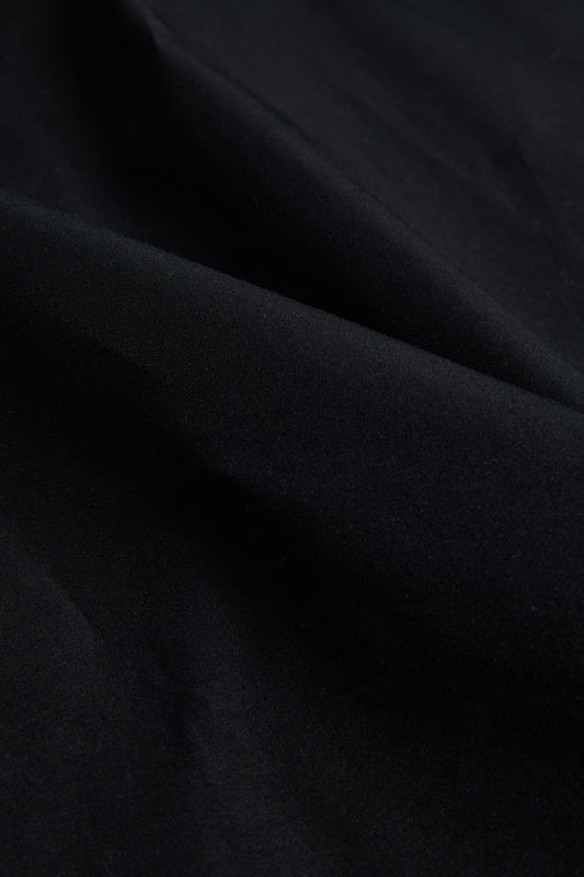 Black organic cotton EtaProof® fabric, dense and waterproof, with subtle folds.
