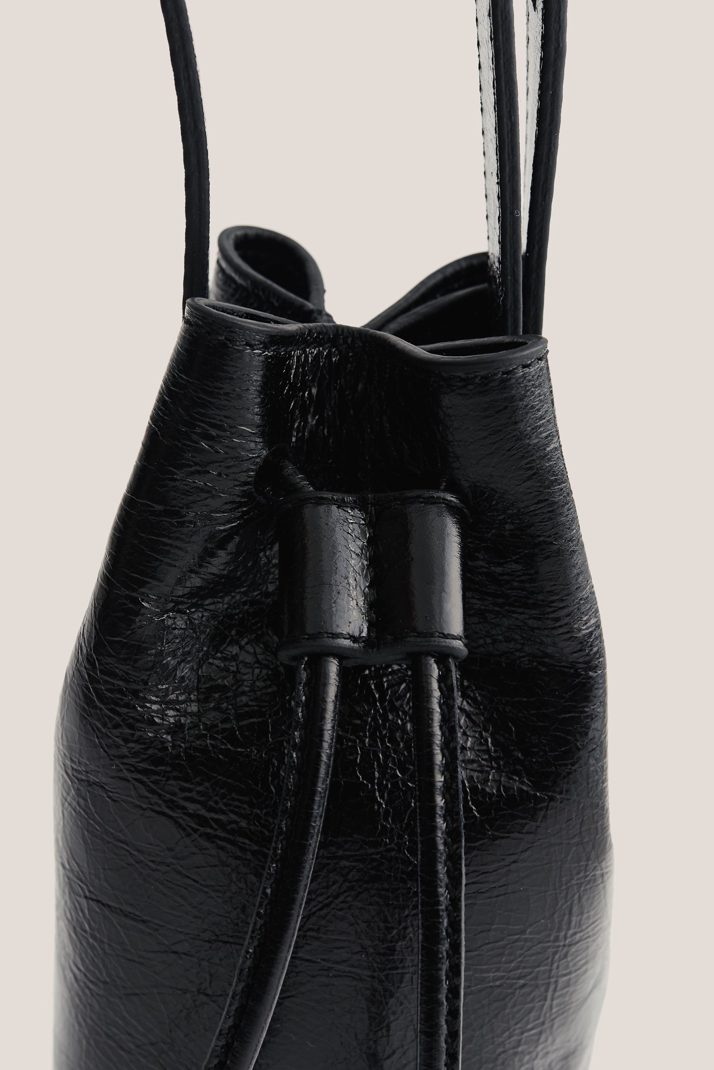 Women's accessories mini round bucket bag, black lwg-certified calf leather with drawstring closure.
