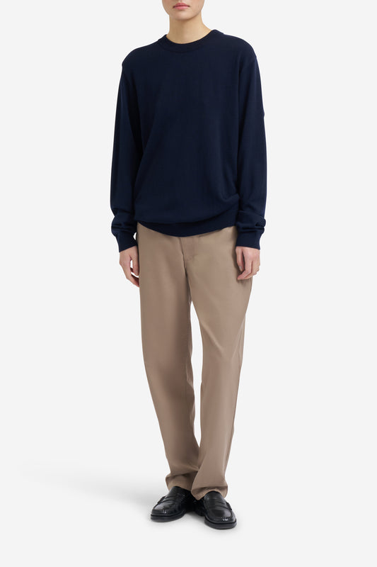 Unisex knit crewneck, 100% mulesing-free merino wool, navy, with rib-knit neck, cuffs, and hem.