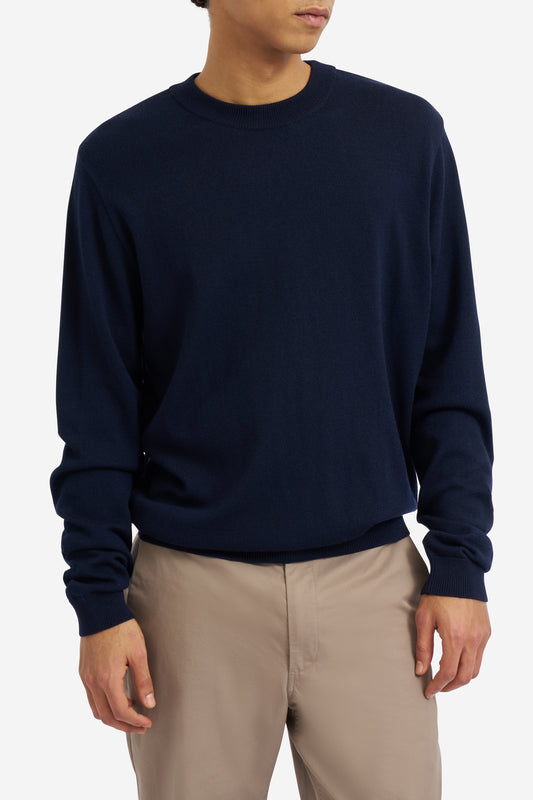 Men's knit crewneck, 100% mulesing-free merino wool, navy, with rib-knit neck, cuffs, and hem.