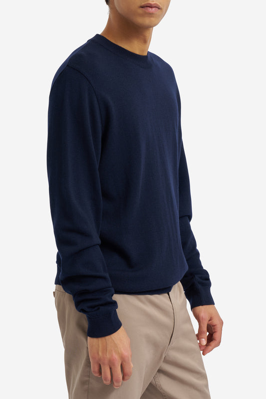 Men's knit crewneck, 100% merino wool, navy, with rib-knit neck, cuffs, and hem.