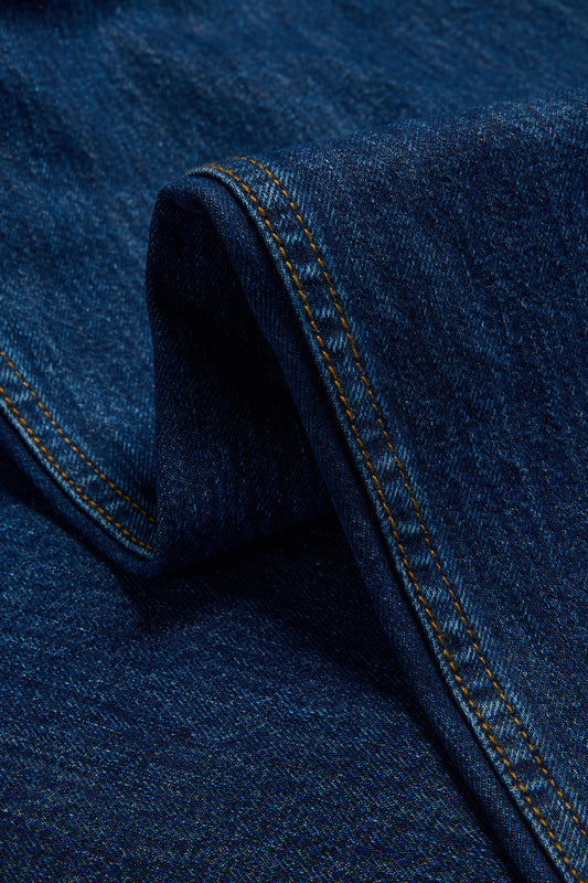 Unisex pants, long-pants, organic cotton, enzyme washed, denim blue jeans with orange stitching.