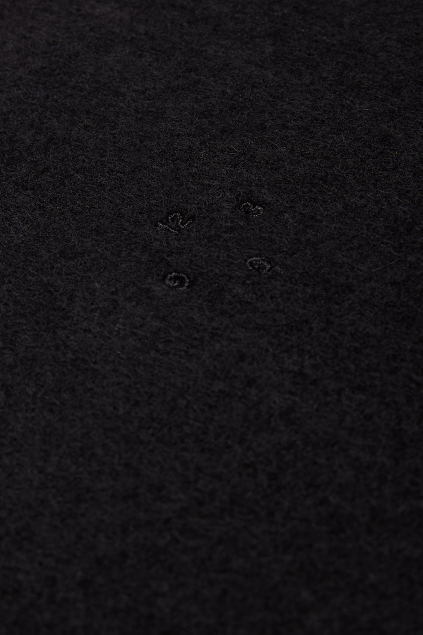 Unisex accessories cashmere scarf, black, with subtle embroidered details.