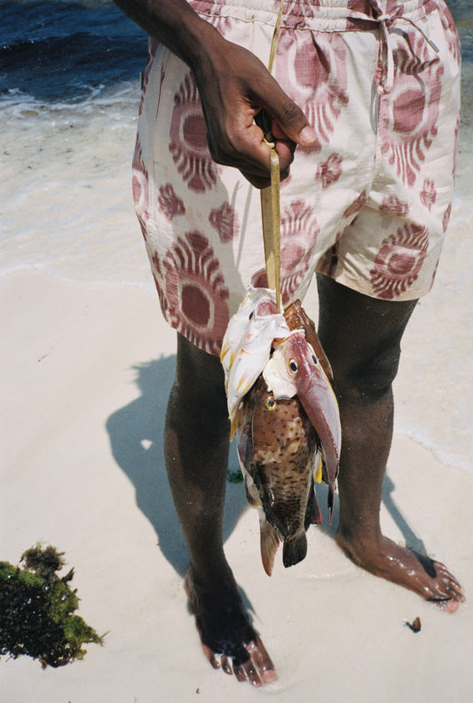 Men's shorts, cotton and recycled polyester blend, ikat-patterned, off-white with reddish-brown print.