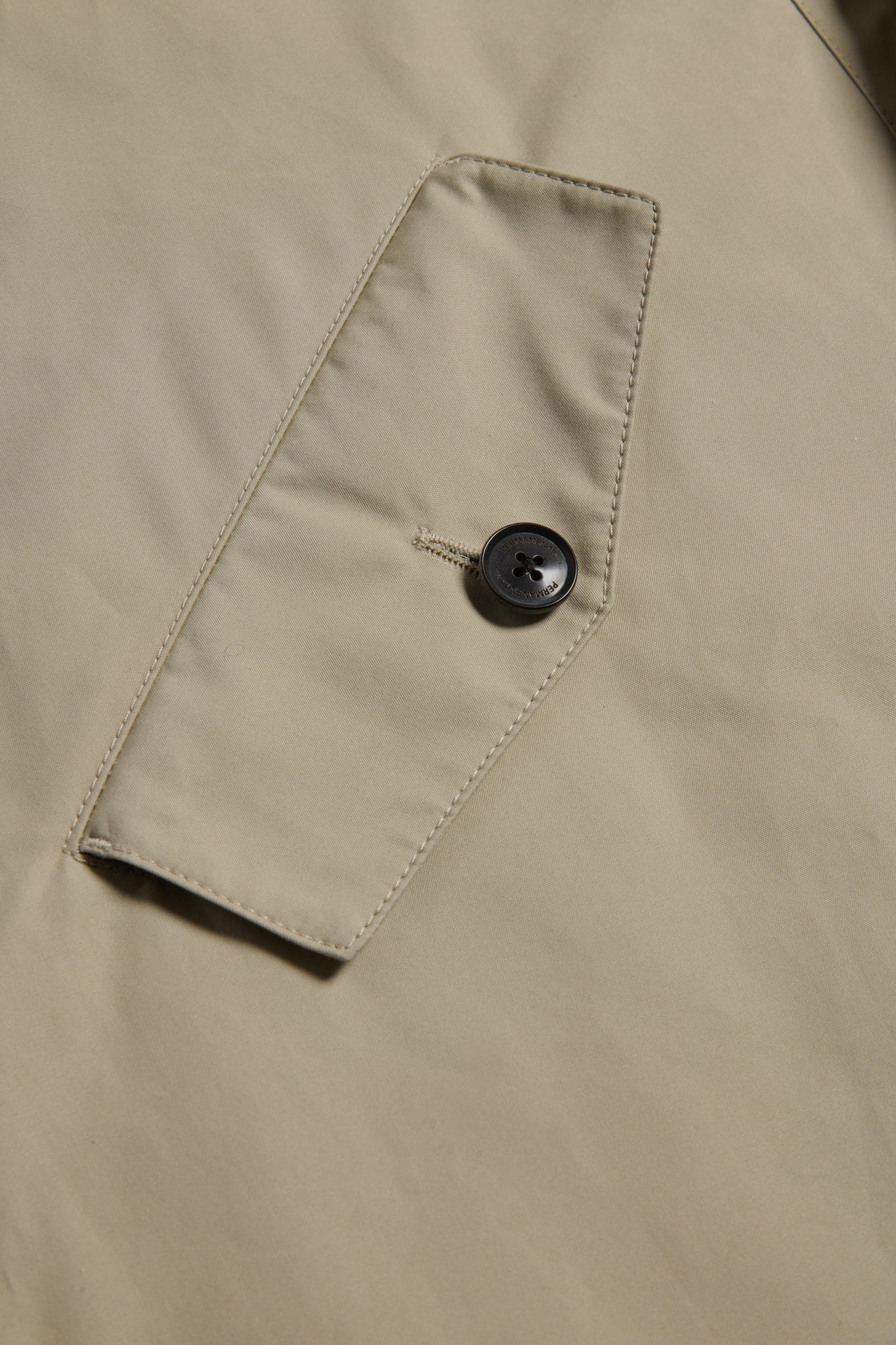 Men's outerwear parka, organic cotton, stone, with flap pocket and black button.