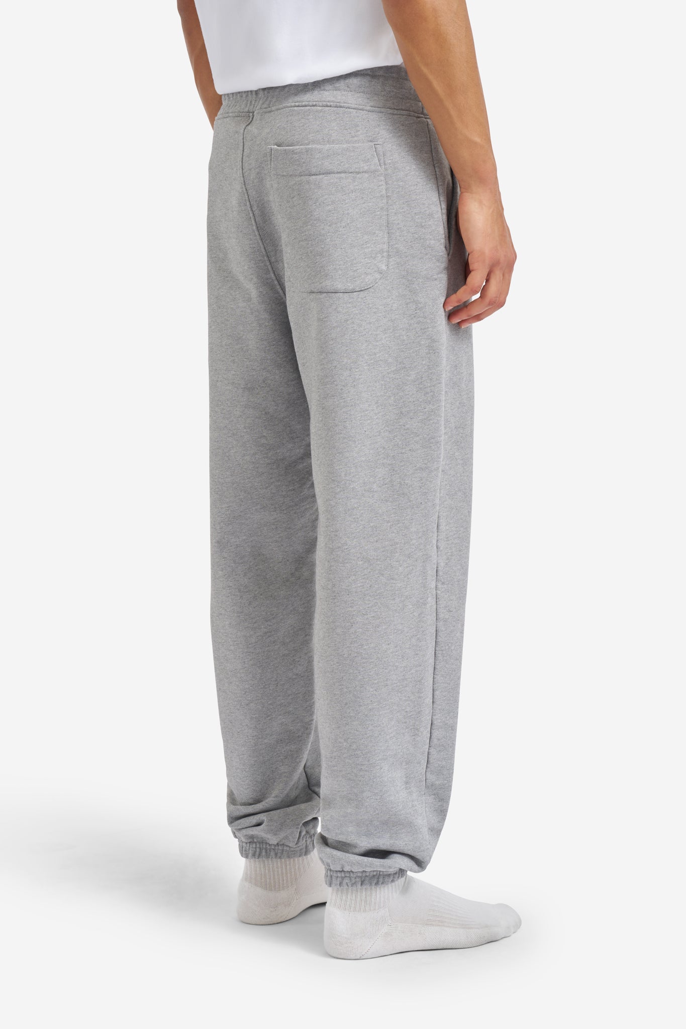 Men's long-pants, organic cotton jersey, grey melange, with back pocket and elastic cuffs.