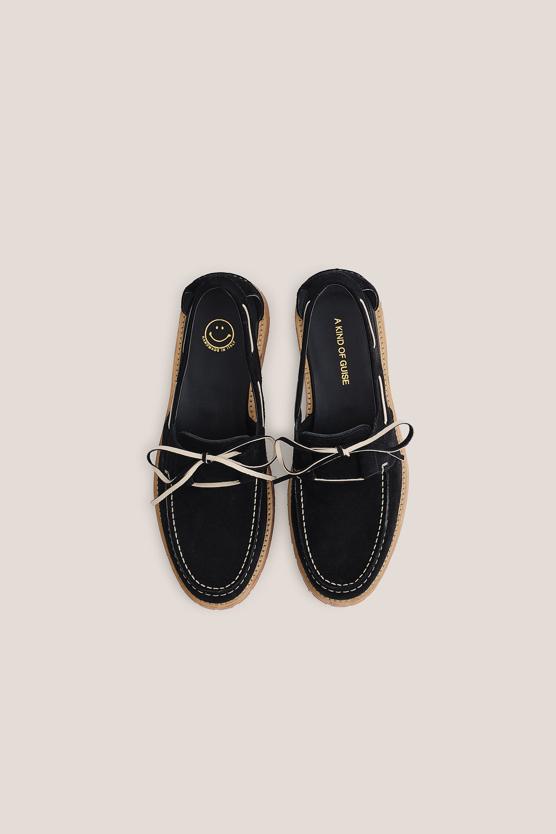 Women's accessories boat sandal, black Italian vegetal cowhide, white lacing, and natural sole.