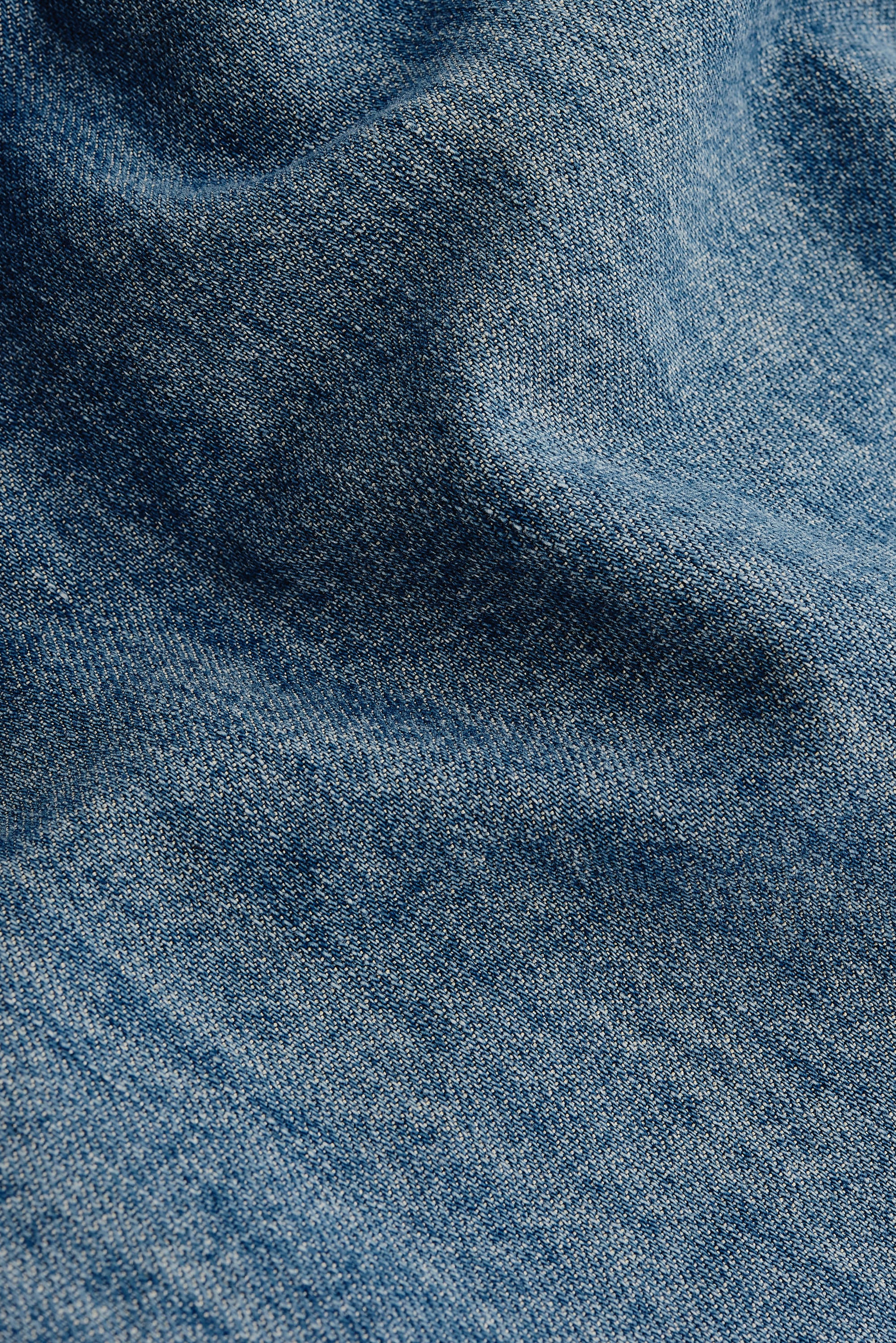 Men's long-sleeved shirt, light blue organic cotton, viscose, and silk denim fabric with vintage-inspired texture.