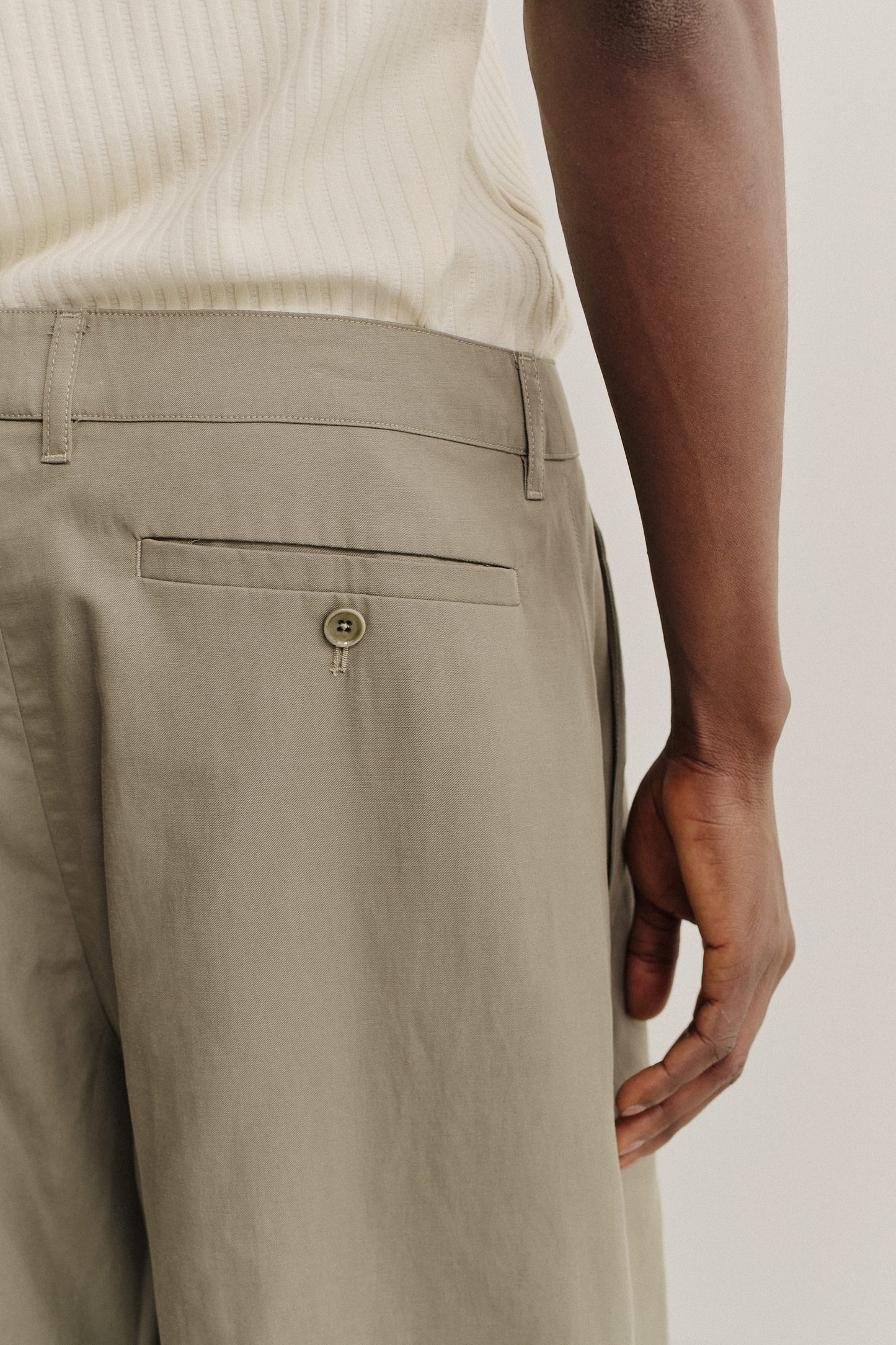 Men's shorts, lyocell-cotton-linen twill, sun-bleached sage, with back welt pocket and button closure.