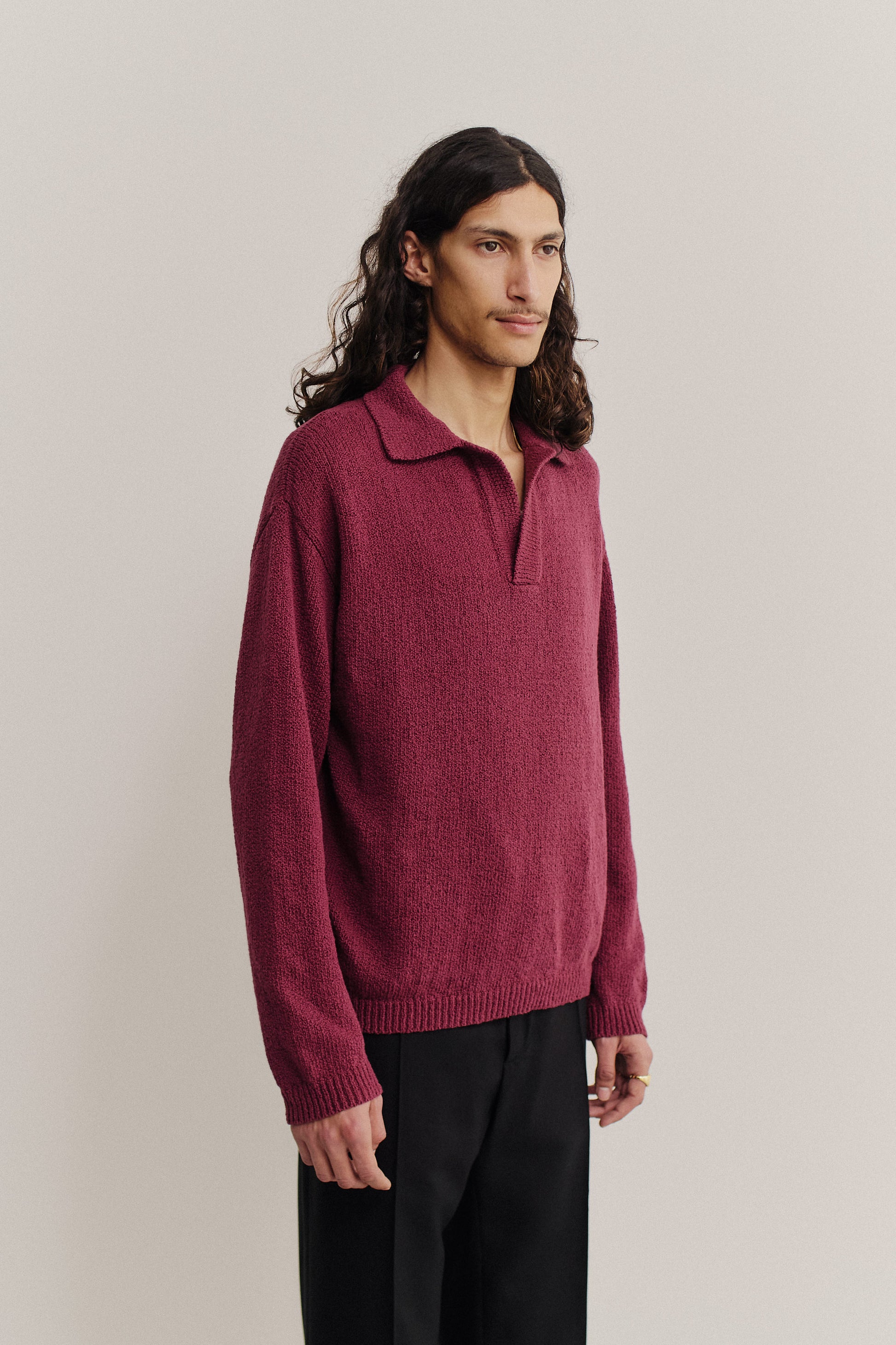 Men's knit long-sleeved polo, organic cotton bouclé, deep red, relaxed fit, open collar.