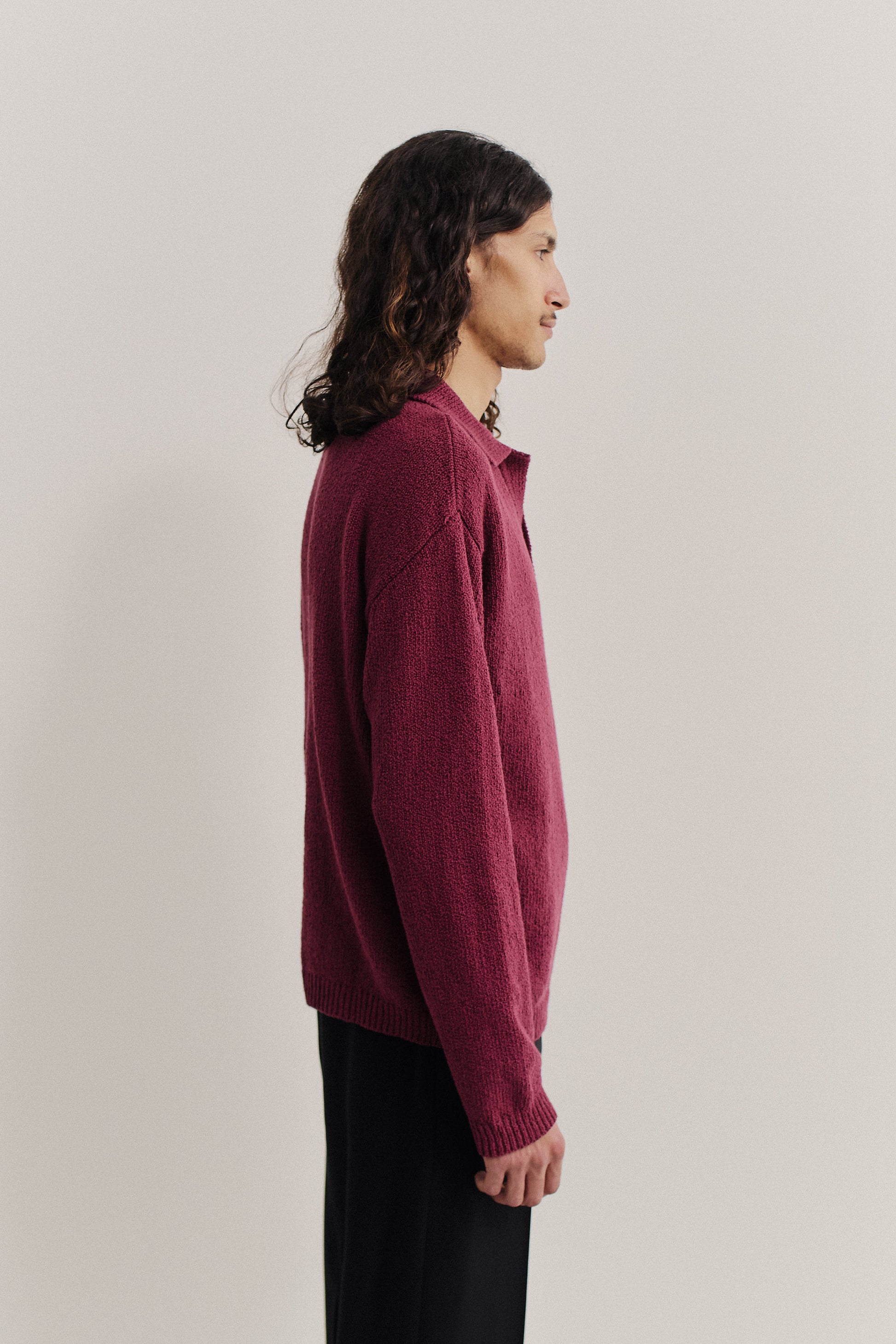Men's knit long-sleeved polo in organic cotton bouclé, featuring an open collar and ribbed trims, in a vibrant magenta.