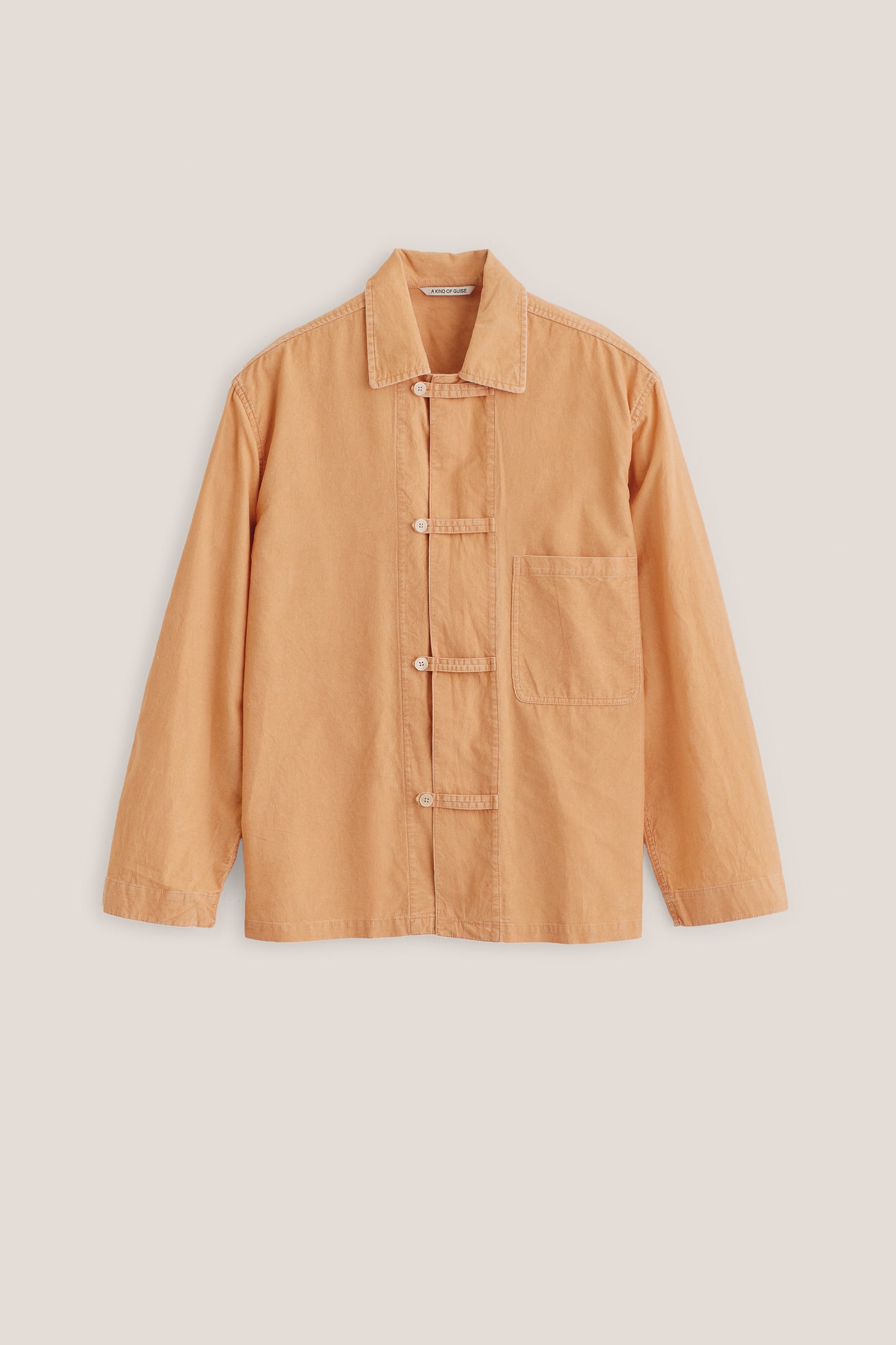 Men's long-sleeved overshirt, 100% cotton light corduroy, garment washed, in a rich peach hue with patch pocket and button fastening.