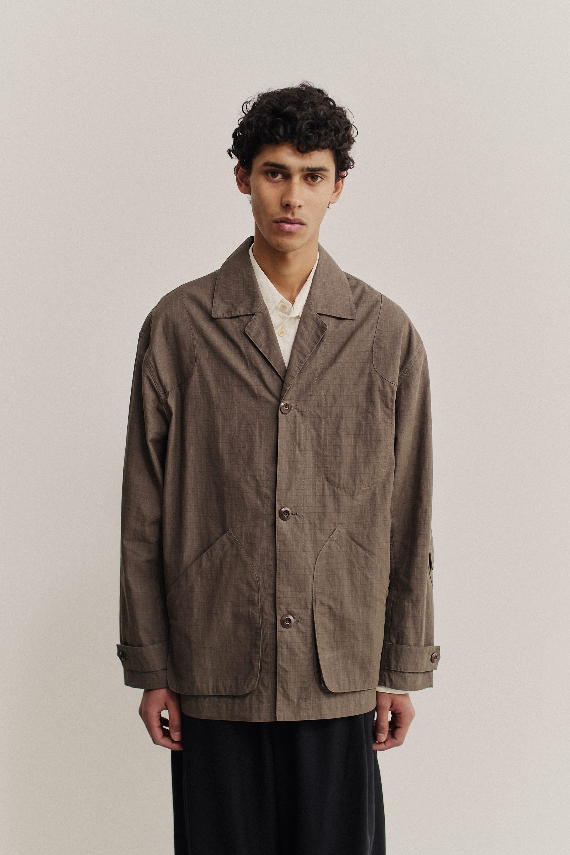 Men's outerwear jacket, cotton blend ripstop, waxed finish, brown, vintage lapel, patch pockets.