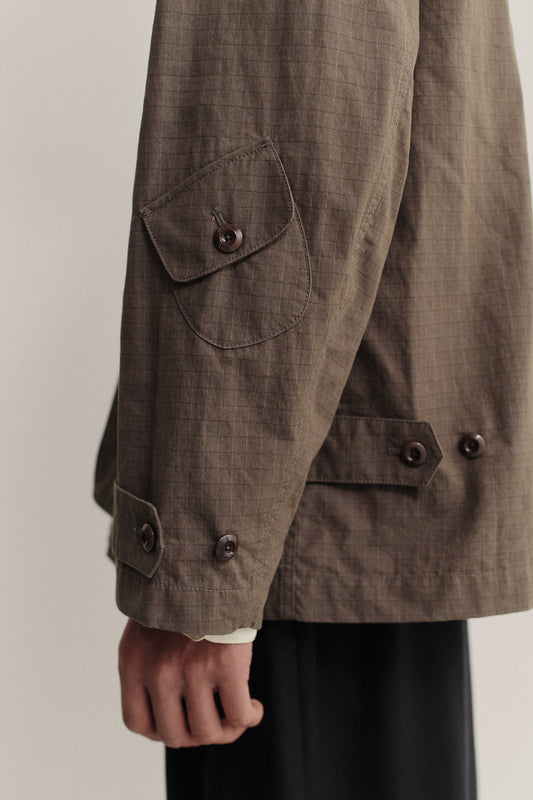 Men's outerwear jacket, cotton blend ripstop, waxed finish, brown, with patch pocket and corozo buttons.