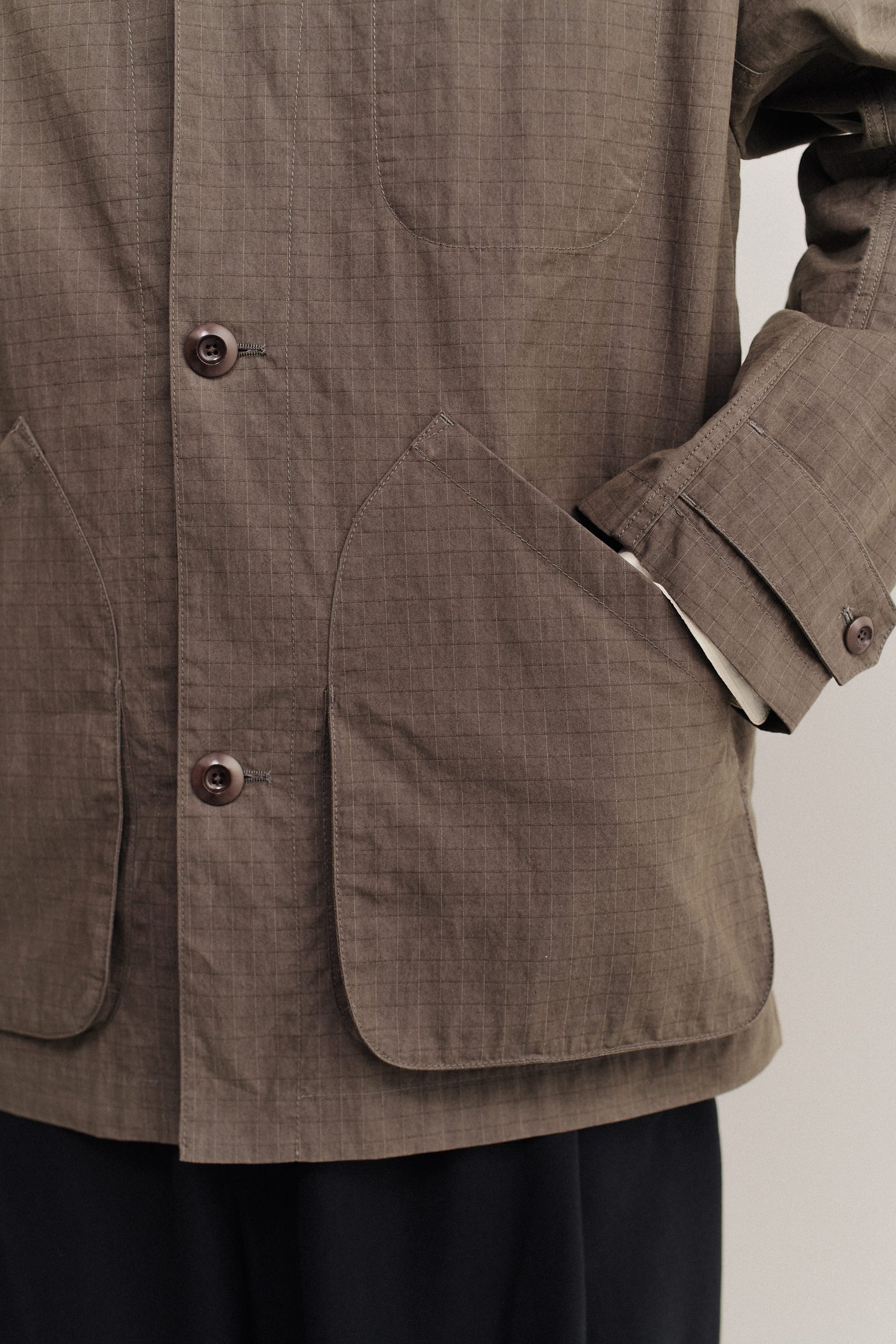 Men's outerwear jacket, cotton blend ripstop, waxed finish, brown, with patch pockets and corozo buttons.