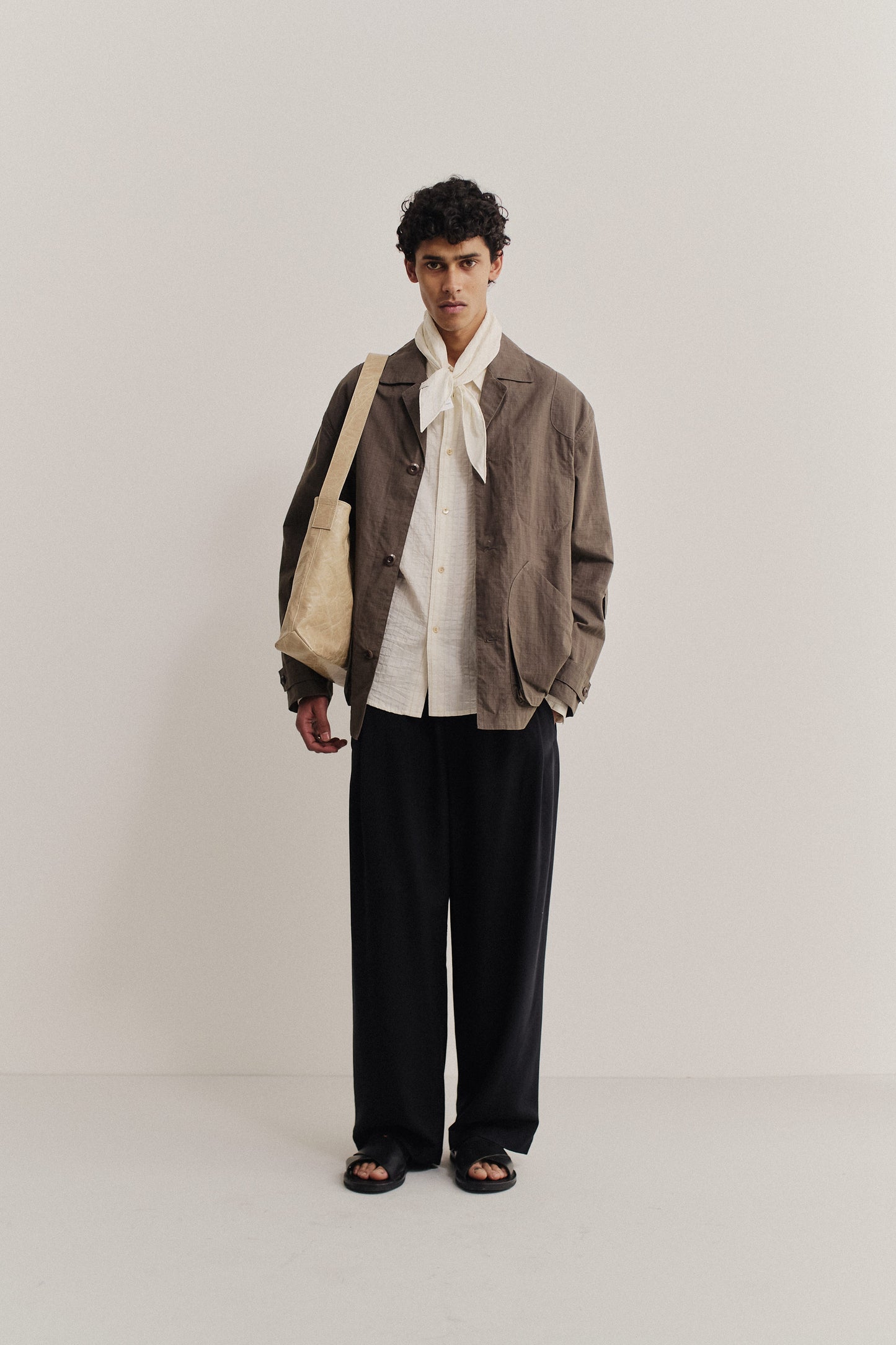 Men's outerwear jacket, cotton blend ripstop, waxed finish, brown, with vintage lapel and patch pockets.