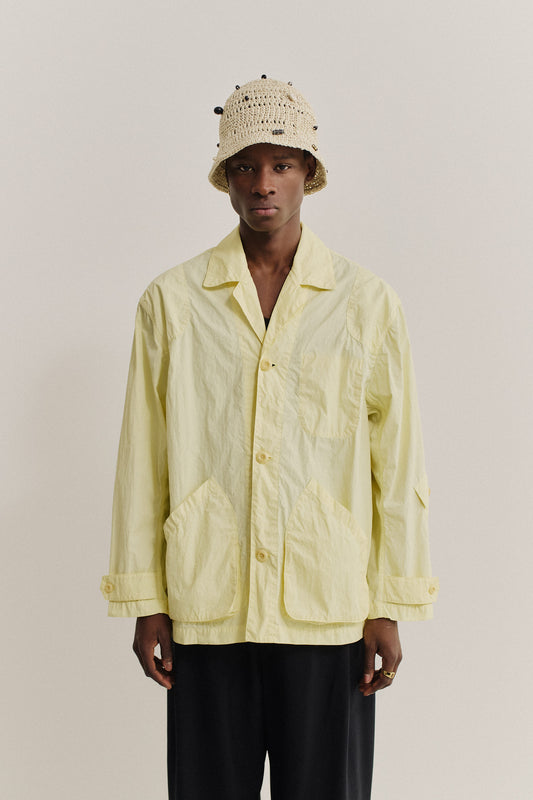 Men's outerwear jacket, recycled polyamide, garment-dyed washed light yellow, vintage-style lapel, patch pockets.