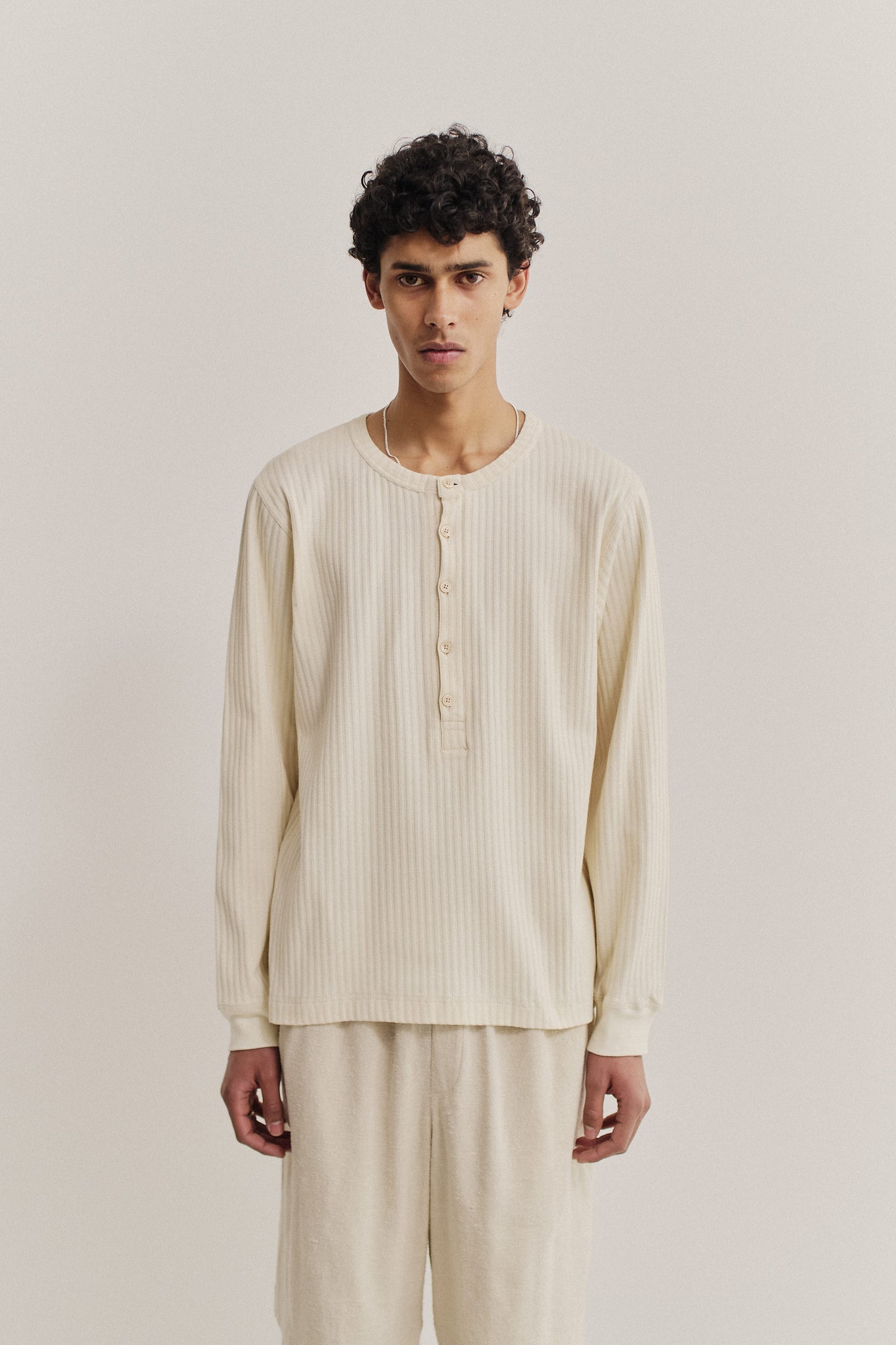 Men's long-sleeved jersey, off-white cotton blend with rib structure and pointelle detailing, button placket.