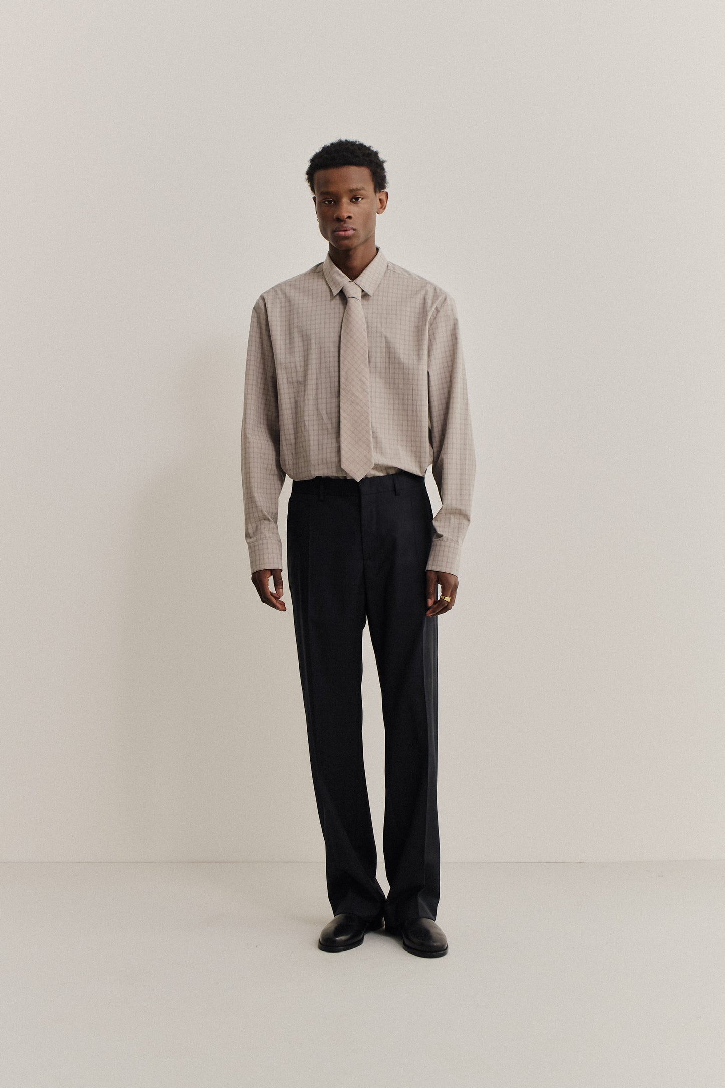 Men's long-pants, 100% virgin wool, black, tailored wide-leg cut with pressed front pleat.