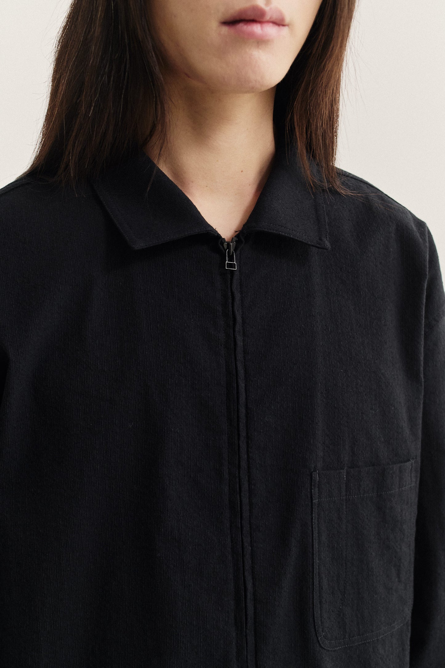 Women's long-sleeved shirt, black cotton blend with irregular wavy stripes, two-way zipper, and patch pocket.