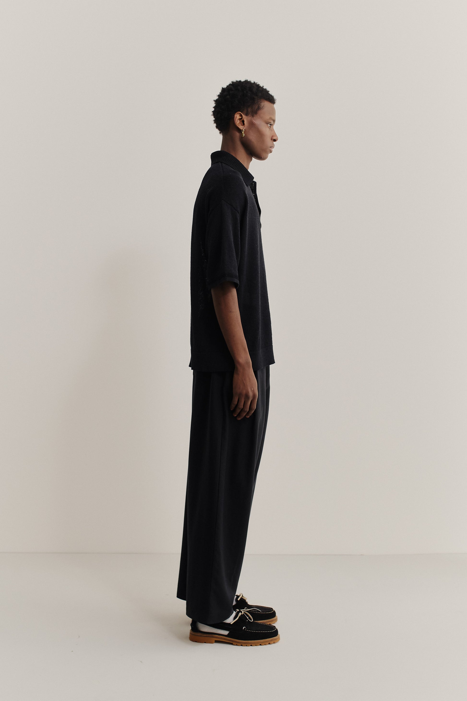 Men's knit short-sleeved polo, linen-organic cotton blend, black, oversized fit, spread collar.