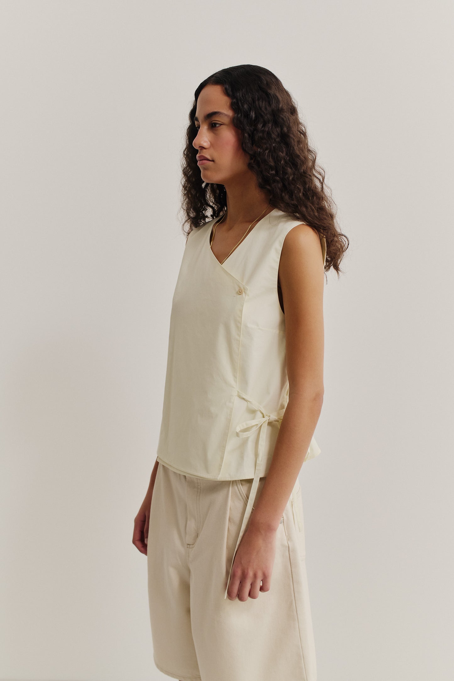 Women's sleeveless wrap shirt, organic cotton, garment washed, light yellow.
