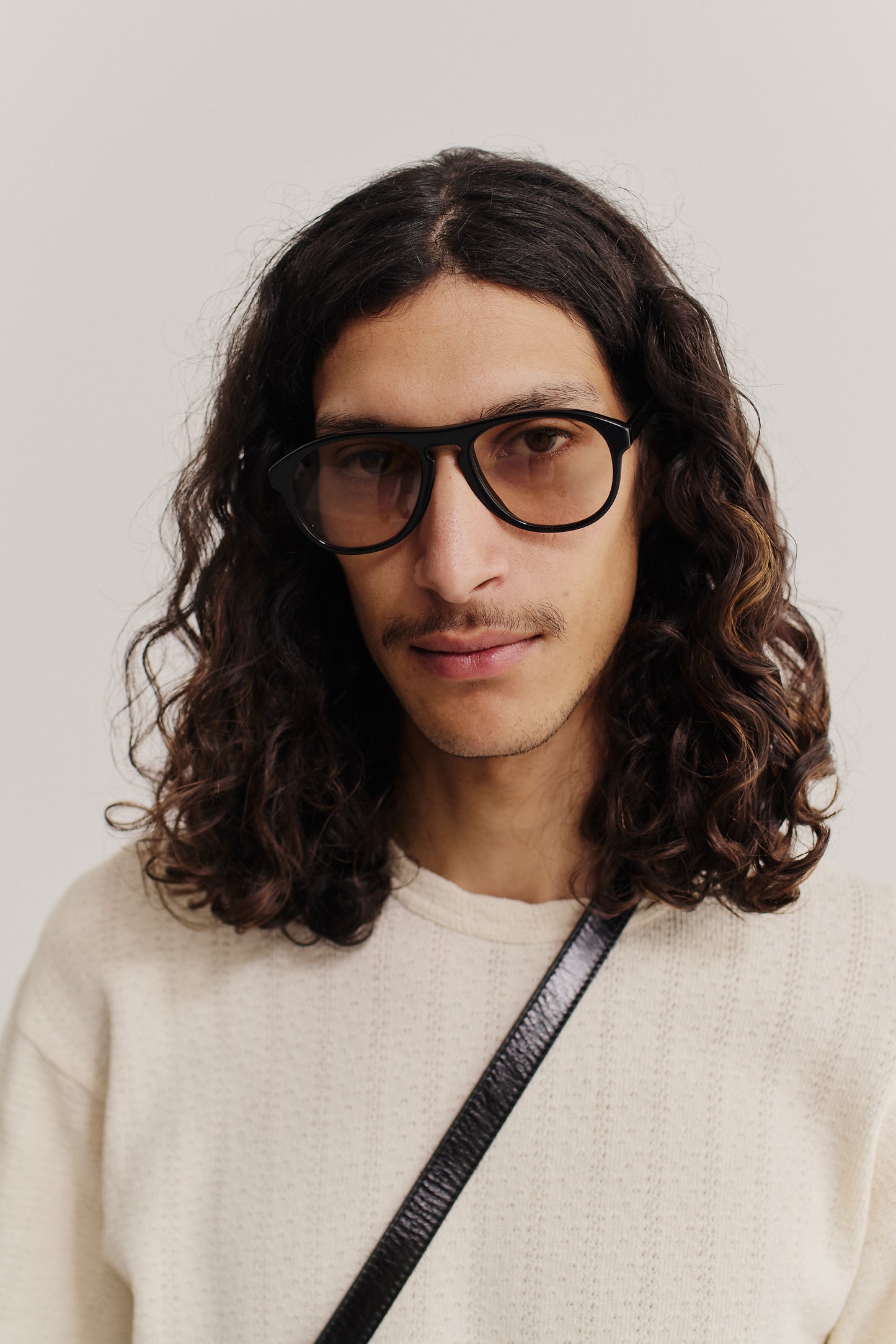 Men's accessories, aviator sunglasses, black acetate frame, rounded vintage-inspired edges, brown Carl Zeiss lenses.