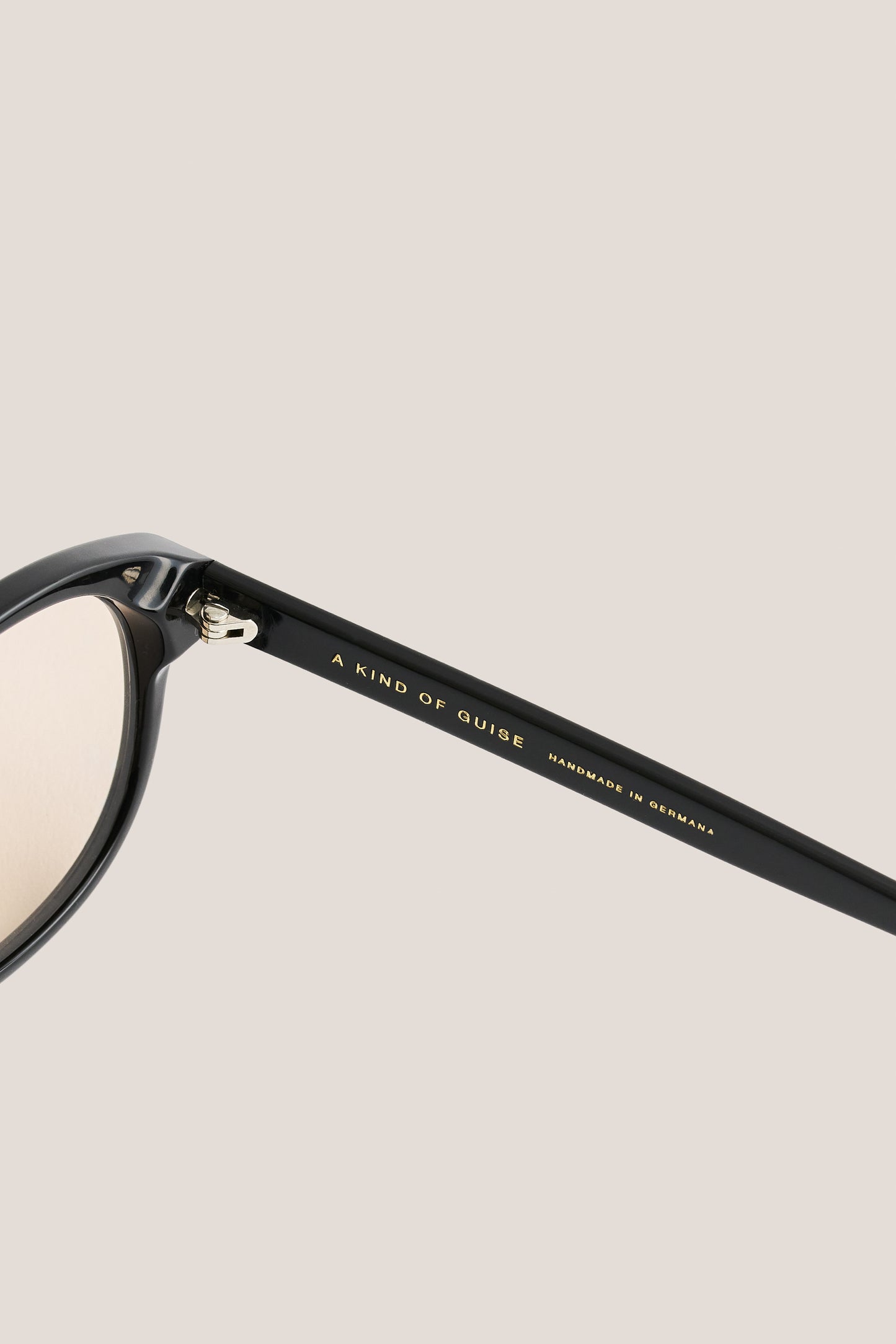 Unisex accessories sunglasses, black acetate aviator frame with rounded vintage edges and light peach lenses.