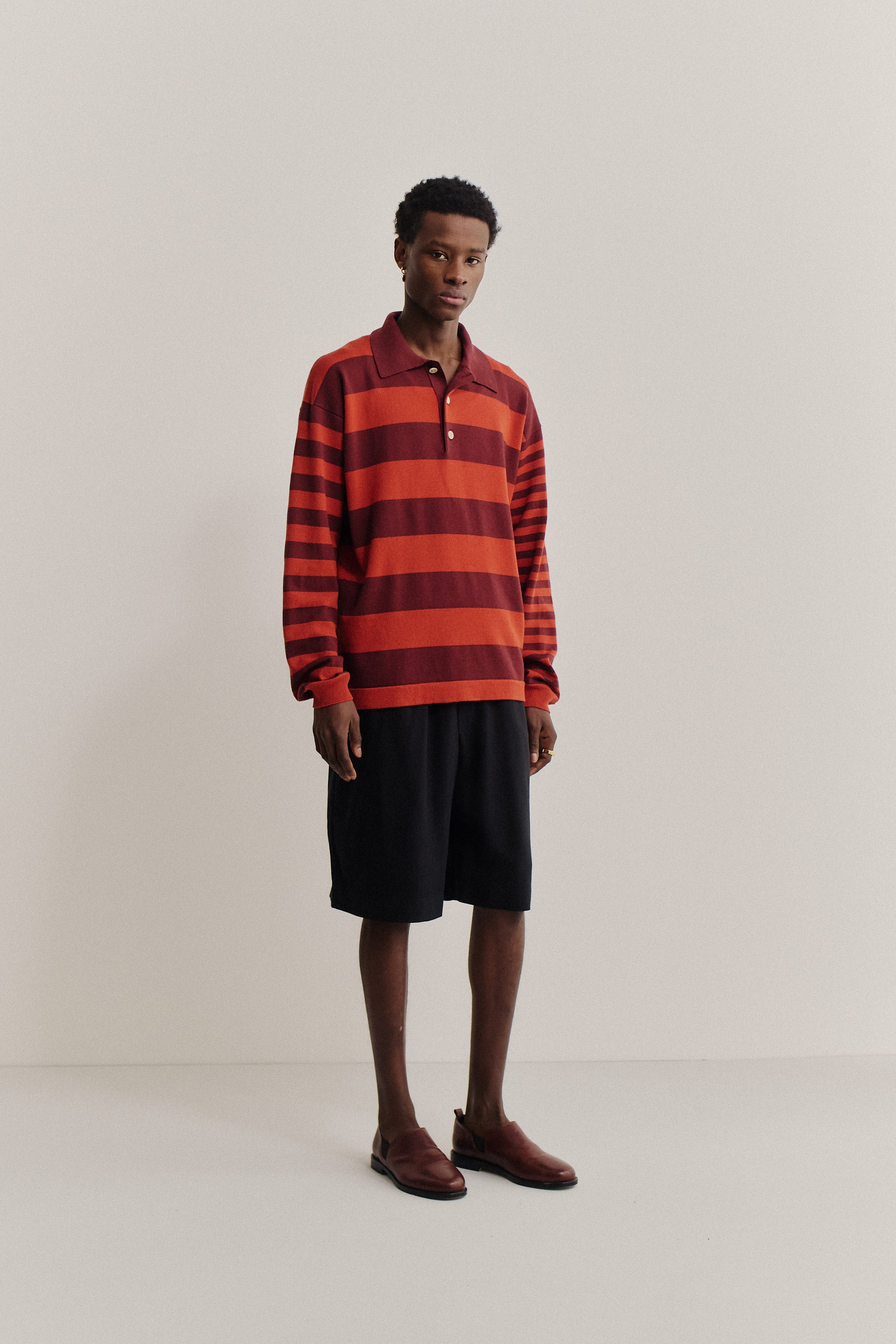 Men's knit long-sleeved polo shirt, 100% fine merino wool, red and burgundy striped.