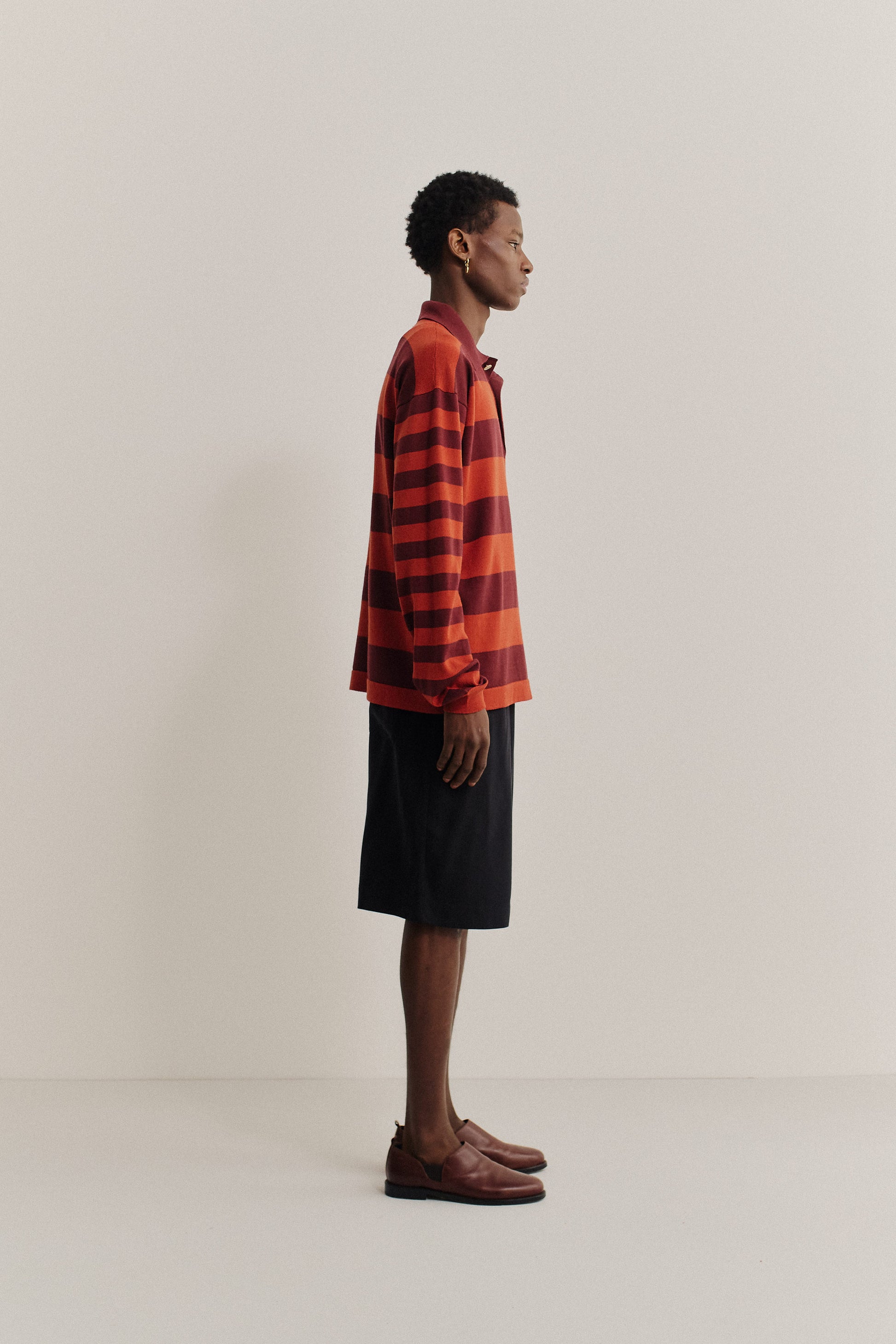 Men's knit long-sleeved polo shirt, 100% fine merino wool, red and burgundy striped.