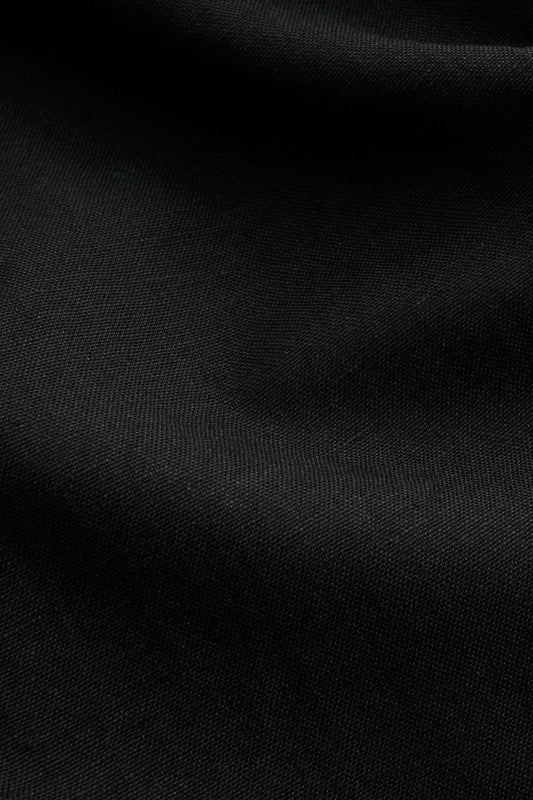 Women's dress, black worsted wool and linen blend fabric with subtle visual depth.