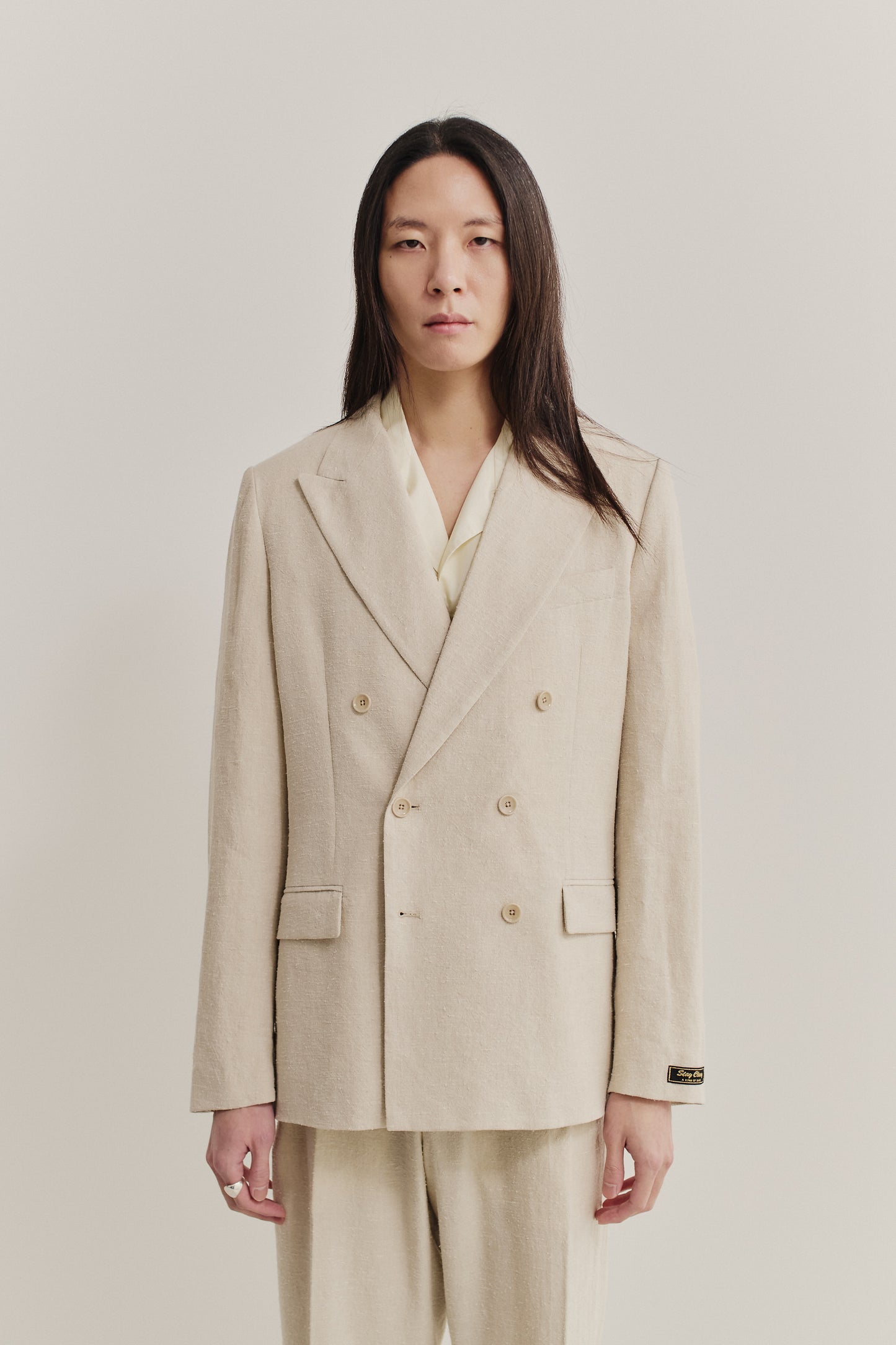 Men's tailoring, double-breasted peak blazer, linen-silk blend, naturally textured, undyed beige.
