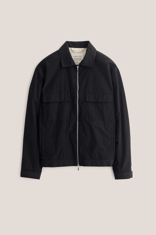 Men's outerwear jacket, black recycled nylon-cotton blend, with flap chest pockets and front zip closure.