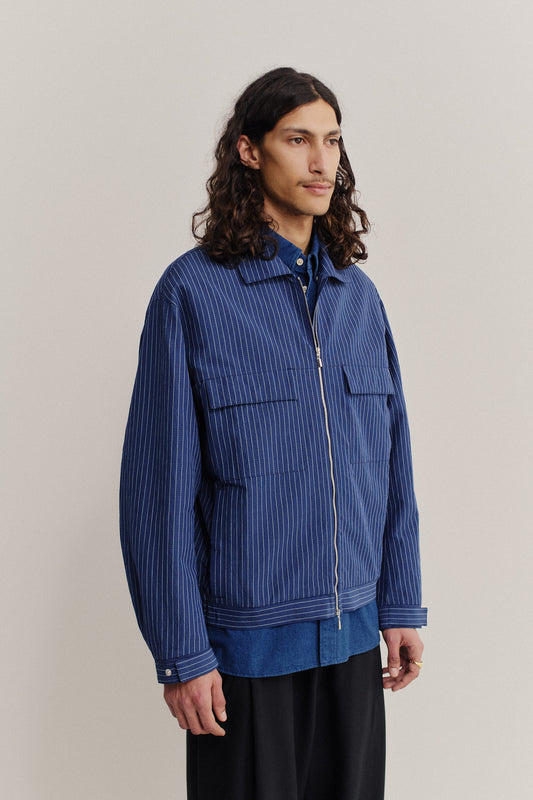 Men's outerwear jacket, cotton-linen seersucker, blue with pinstripes, boxy silhouette, flap pockets, front zip.