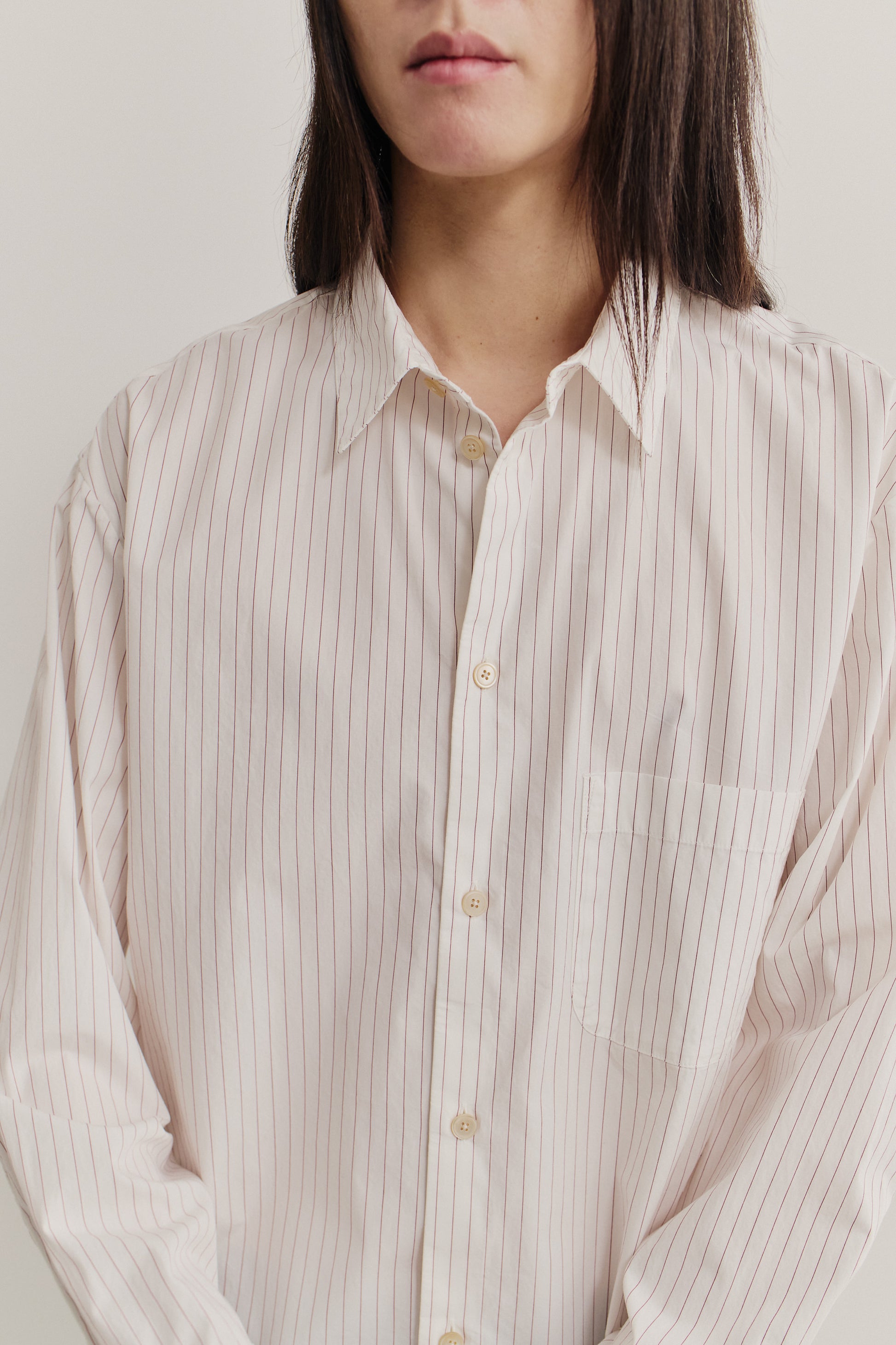 Women's long-sleeved shirt, 100% cotton, off-white with burgundy pinstripes, oversized fit, front pocket.