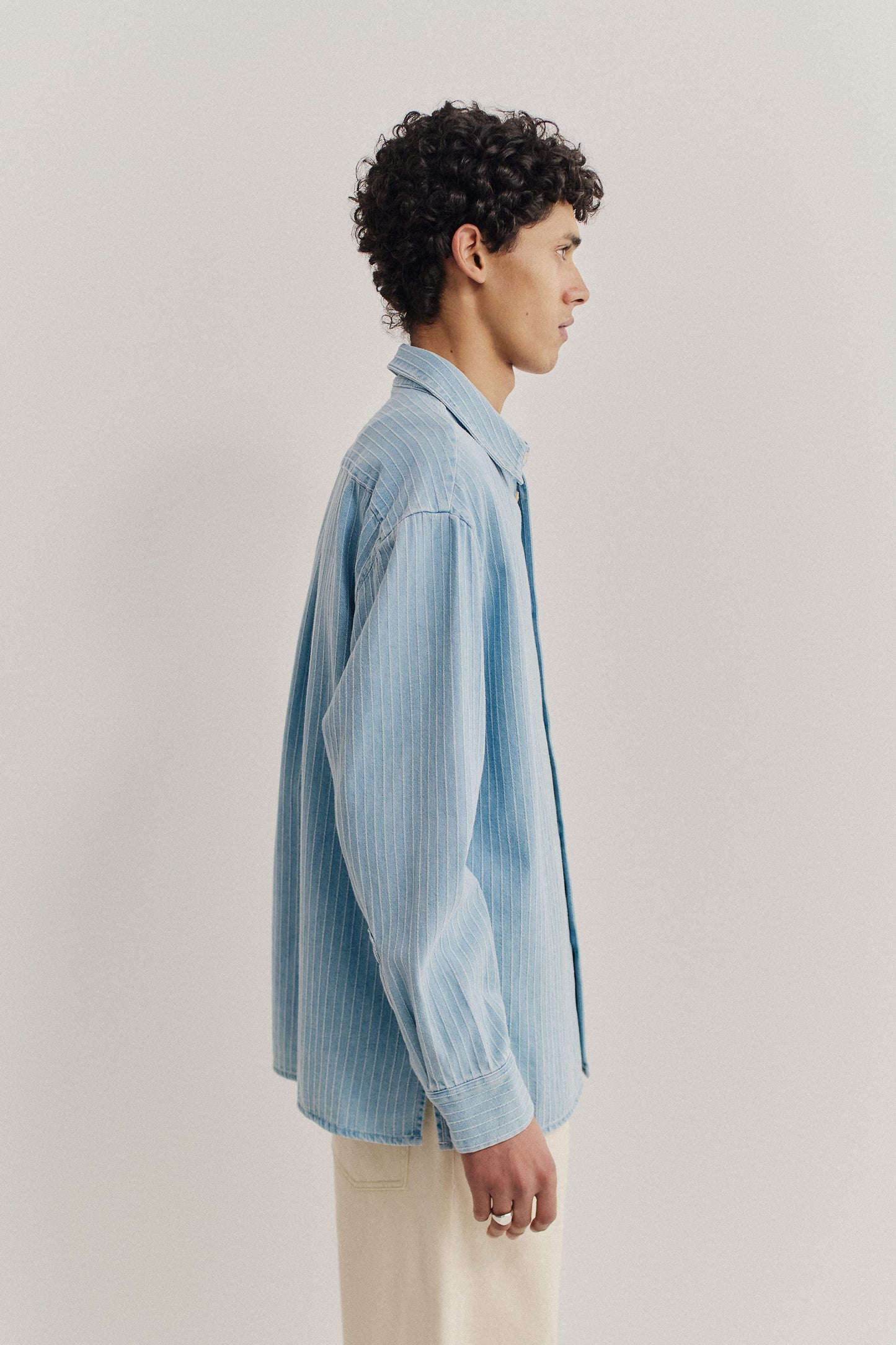 Men's long-sleeved shirt, organic cotton denim, washed light blue with pinstripes, oversized fit.
