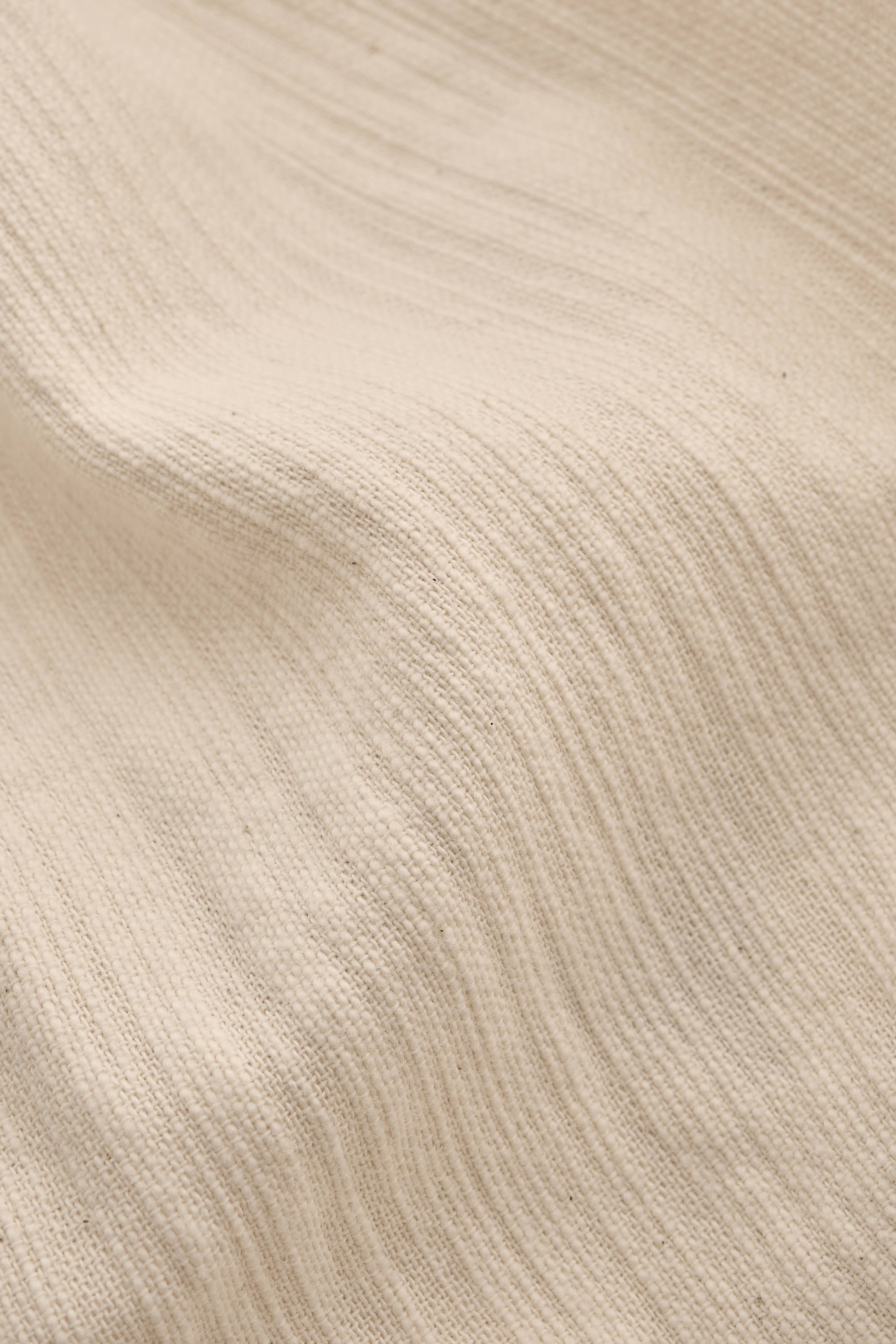 Men's long-sleeved shirt, recycled cotton mix with textured weave, natural slubbed effect, in a light beige color.