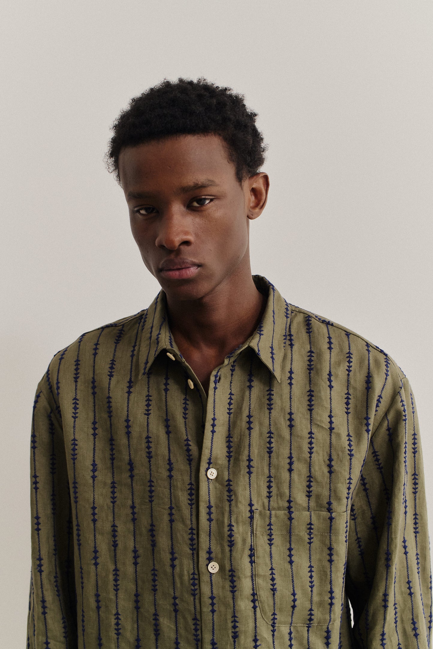 Men's long-sleeved shirt, linen, embroidered, olive green with navy pattern.