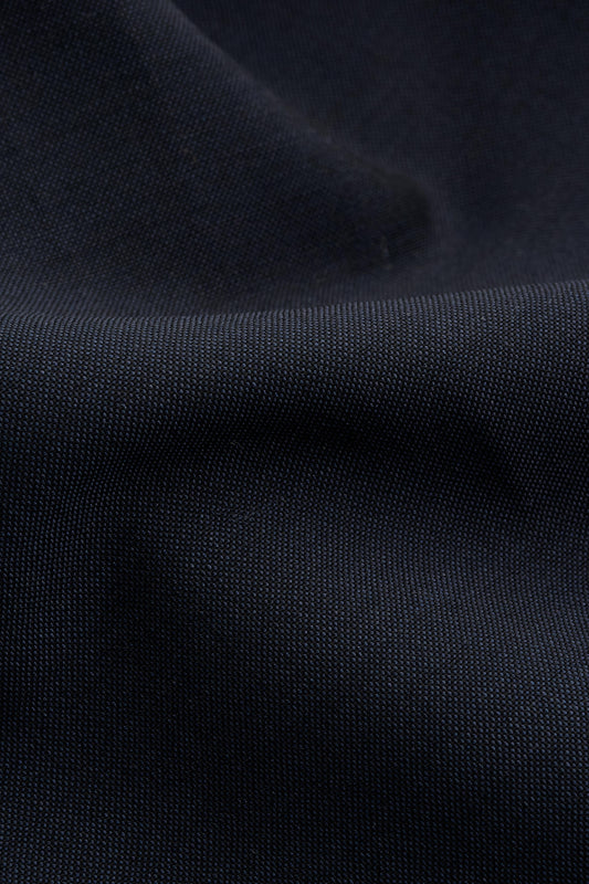Unisex shorts, dark navy 100% virgin wool, crisp hand feel, single side pleat, slanted pockets.