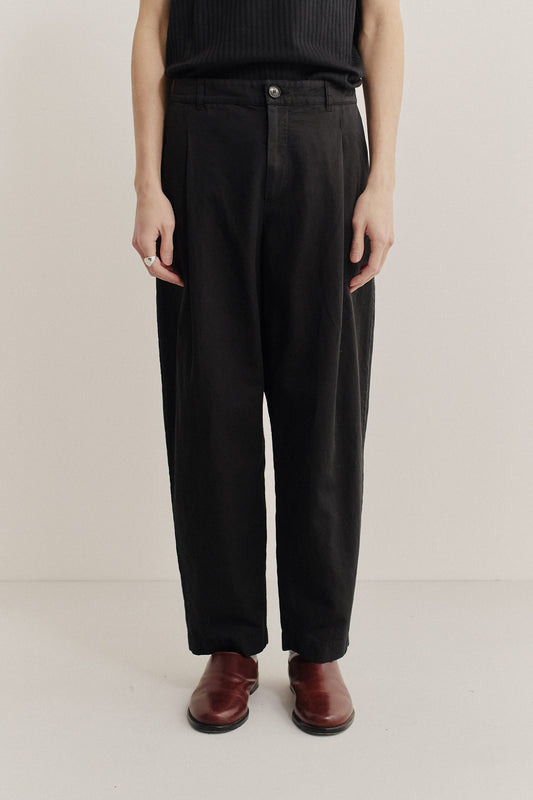 Men's long-pants, linen and cotton blend, garment-dyed black, with single front pleats and tapered leg.
