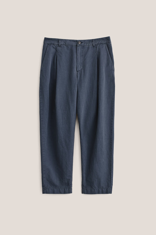 Men's long-pants, cotton-linen blend, garment dyed navy, with single front pleats and cropped tapered leg.
