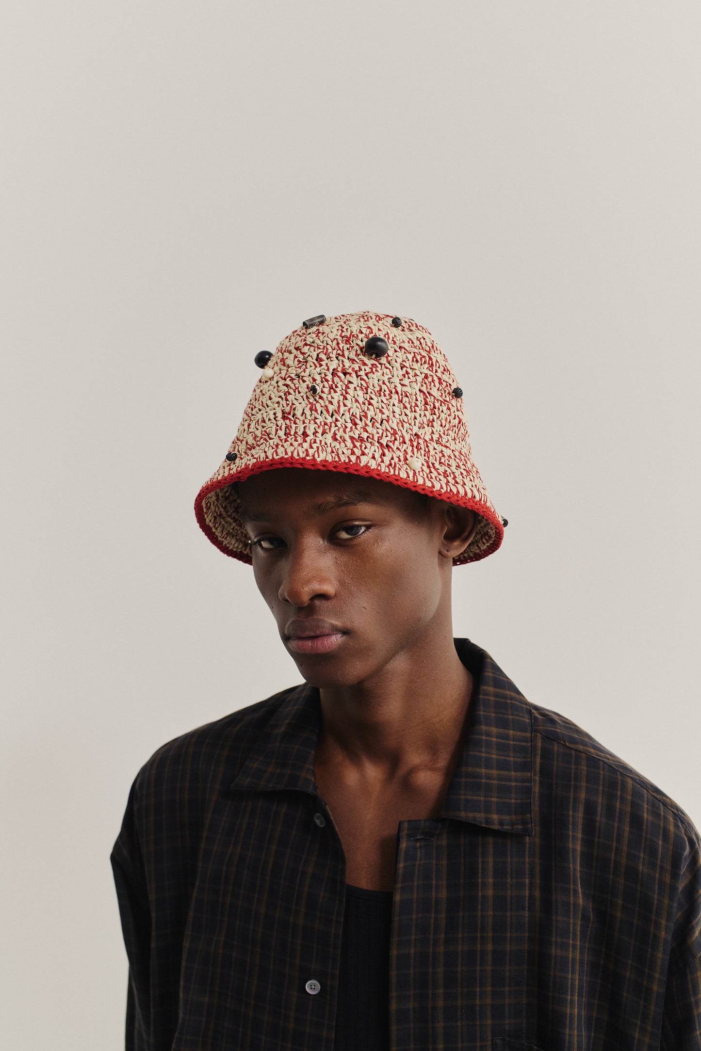 Men's accessories bucket hat, crocheted viscose-linen-cotton blend in red and natural, decorated with black beads.