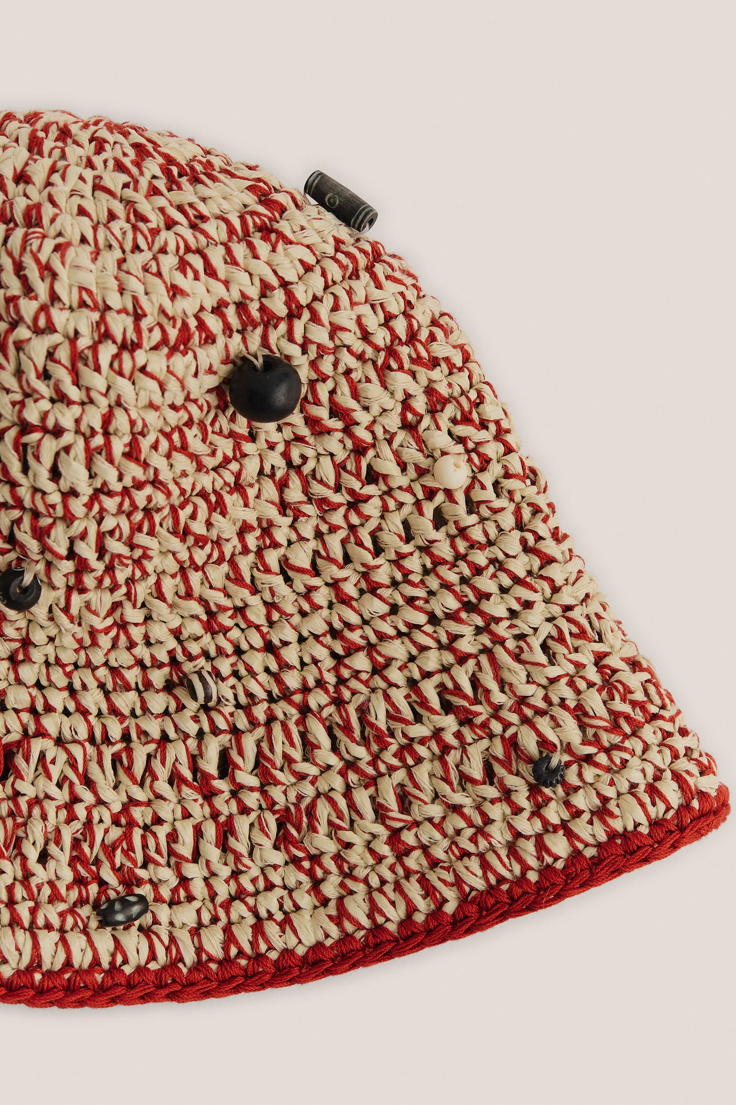 Women's accessories bucket hat, crocheted viscose-linen blend with red and natural raffia look, decorated with mussels and beads.