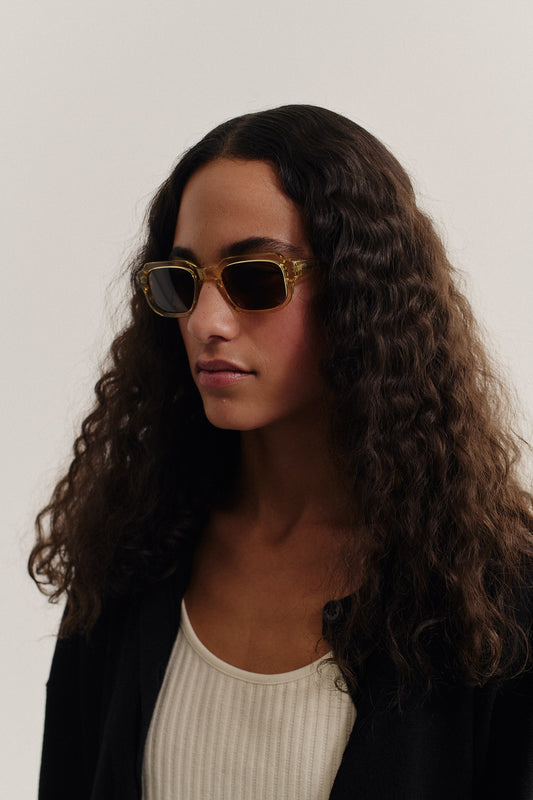 Women's accessories sunglasses, transparent olive acetate, rectangular frame, dark lenses.
