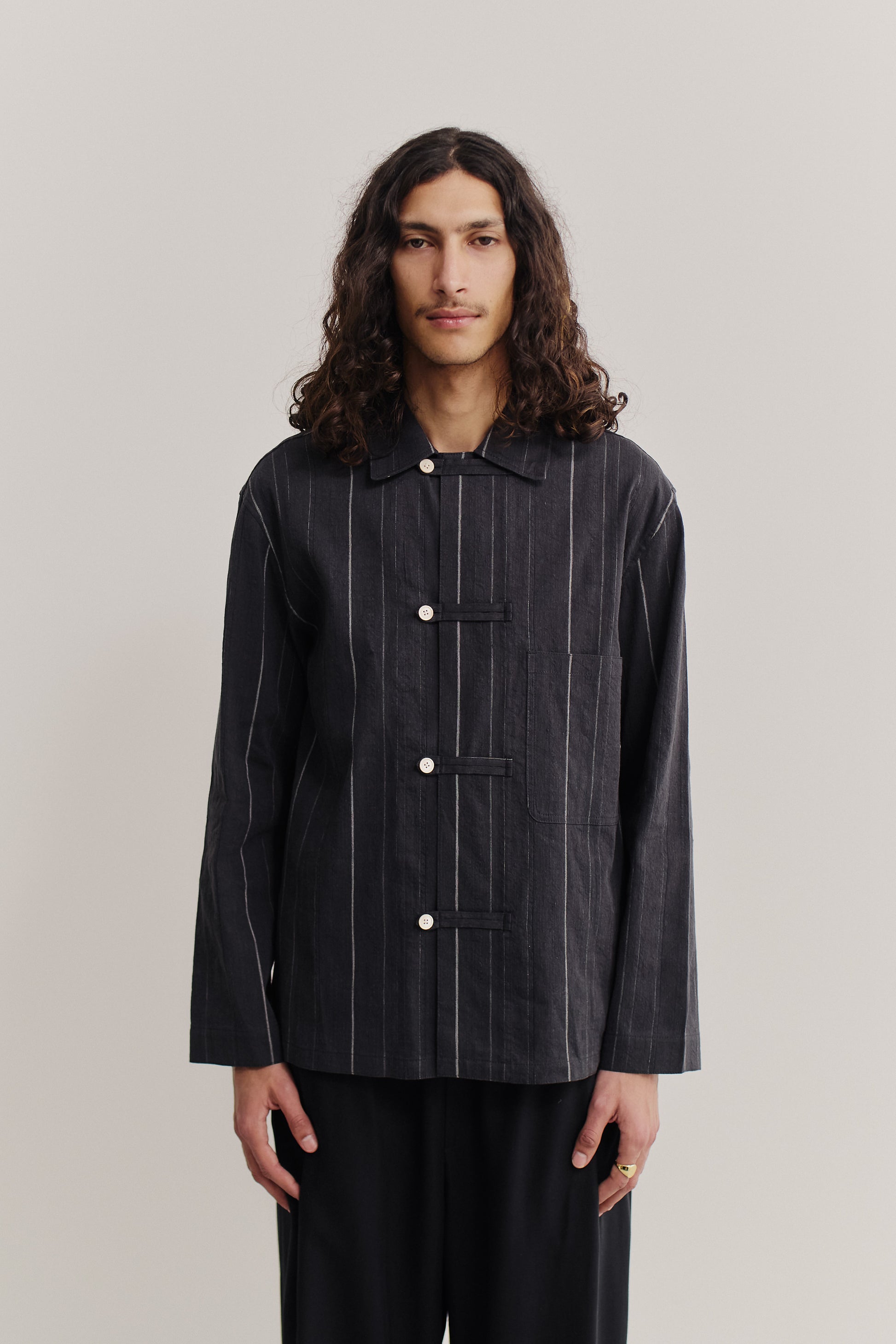 Men's long-sleeved overshirt, black cotton-linen blend with white stripes, front patch pocket, and button fastening.