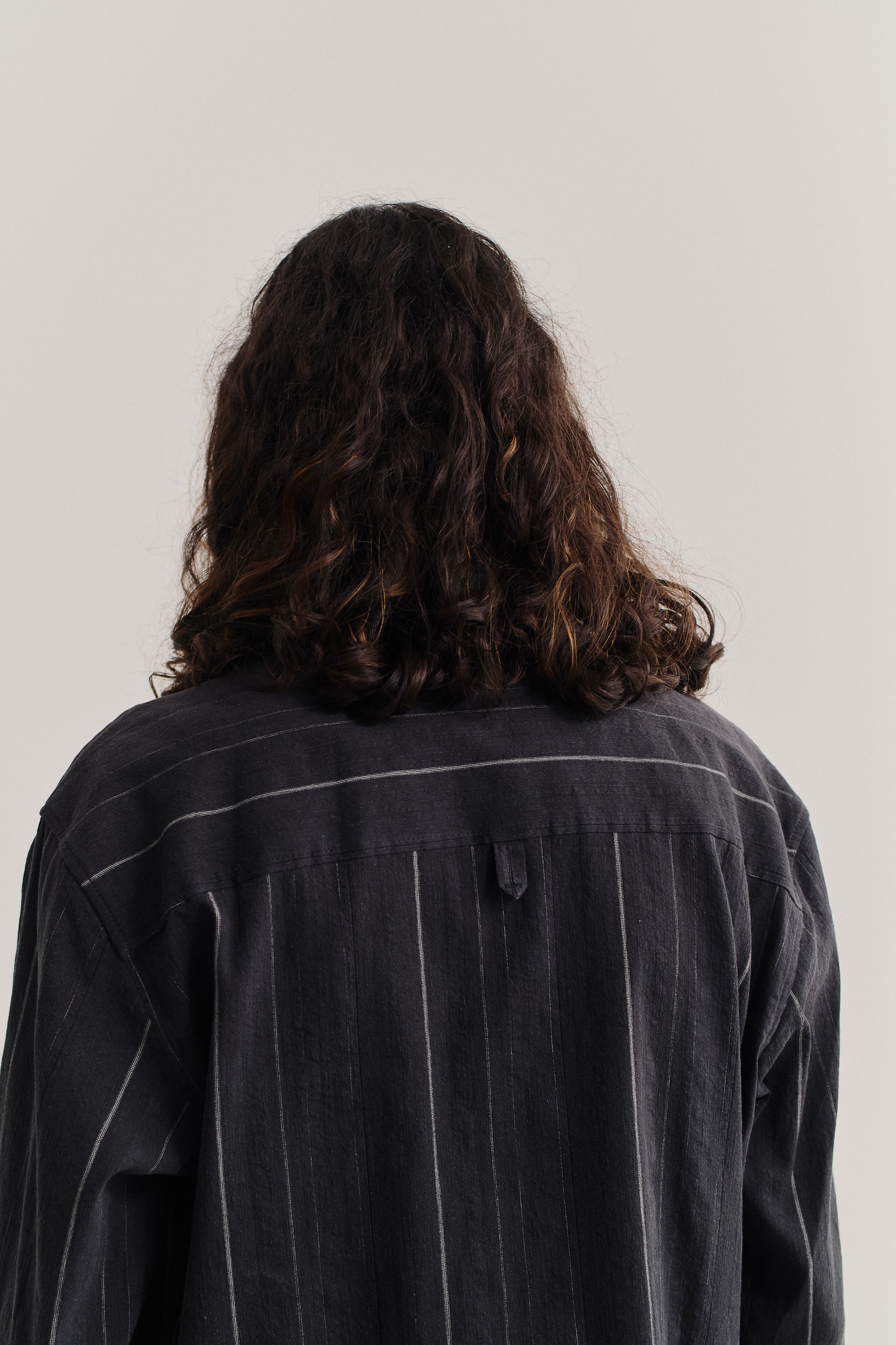 Men's long-sleeved overshirt, cotton-linen blend, washed black with subtle white stripes.