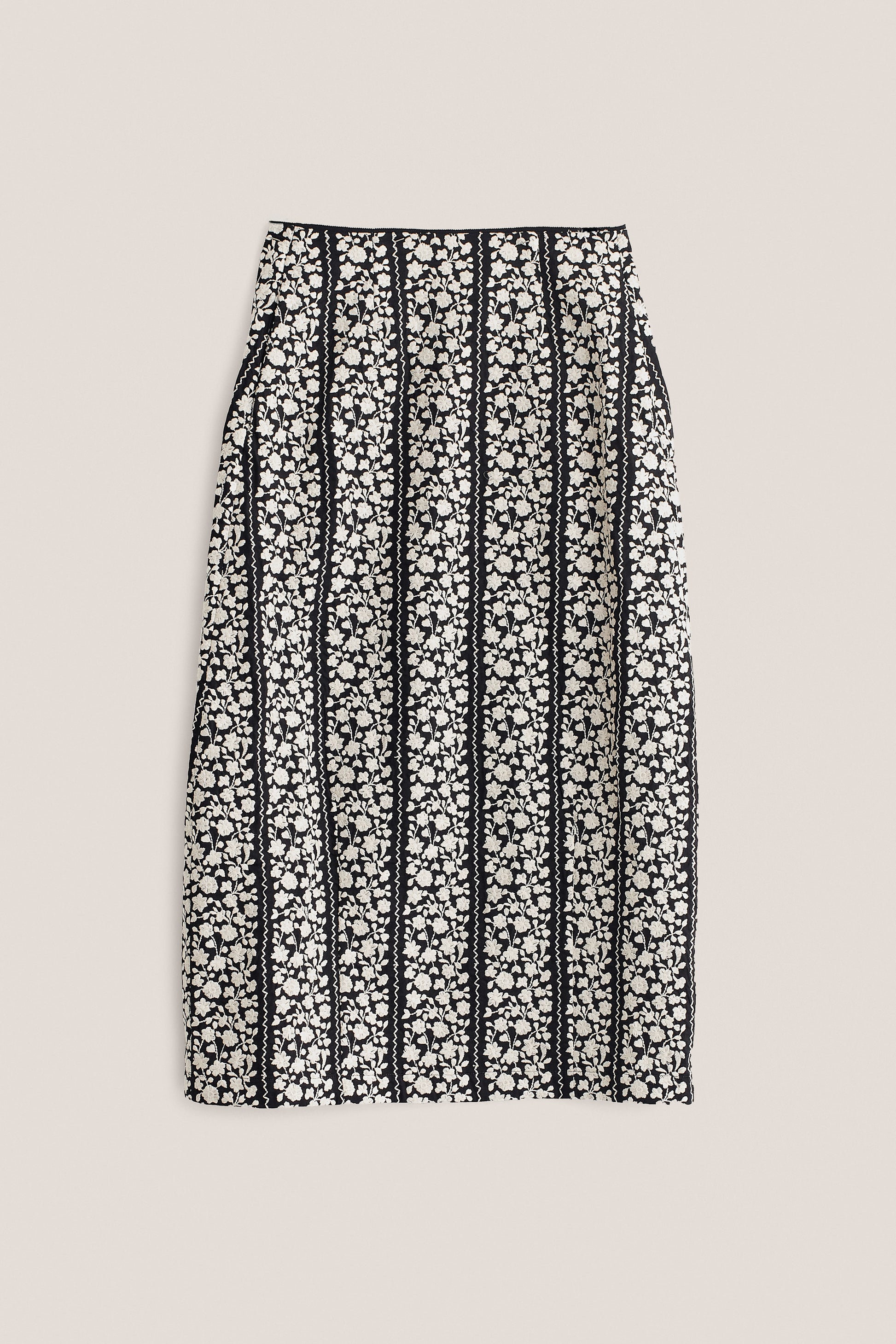 Women's skirt, midi, 100% cotton, black with white embroidered floral blocks and wavy lines.