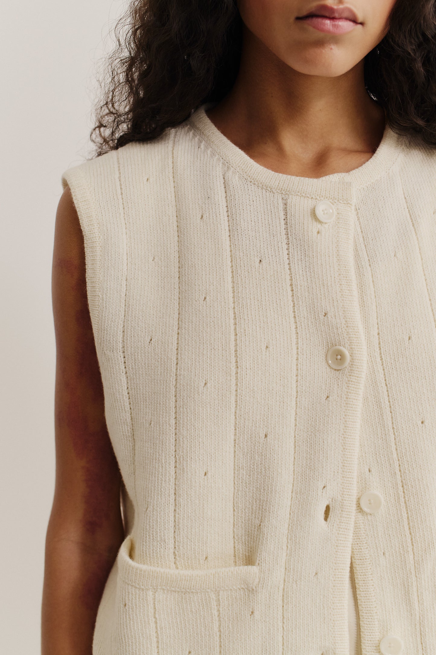Women's knit vest, 100% merino wool, ajour knit, off-white, with button front and pocket.