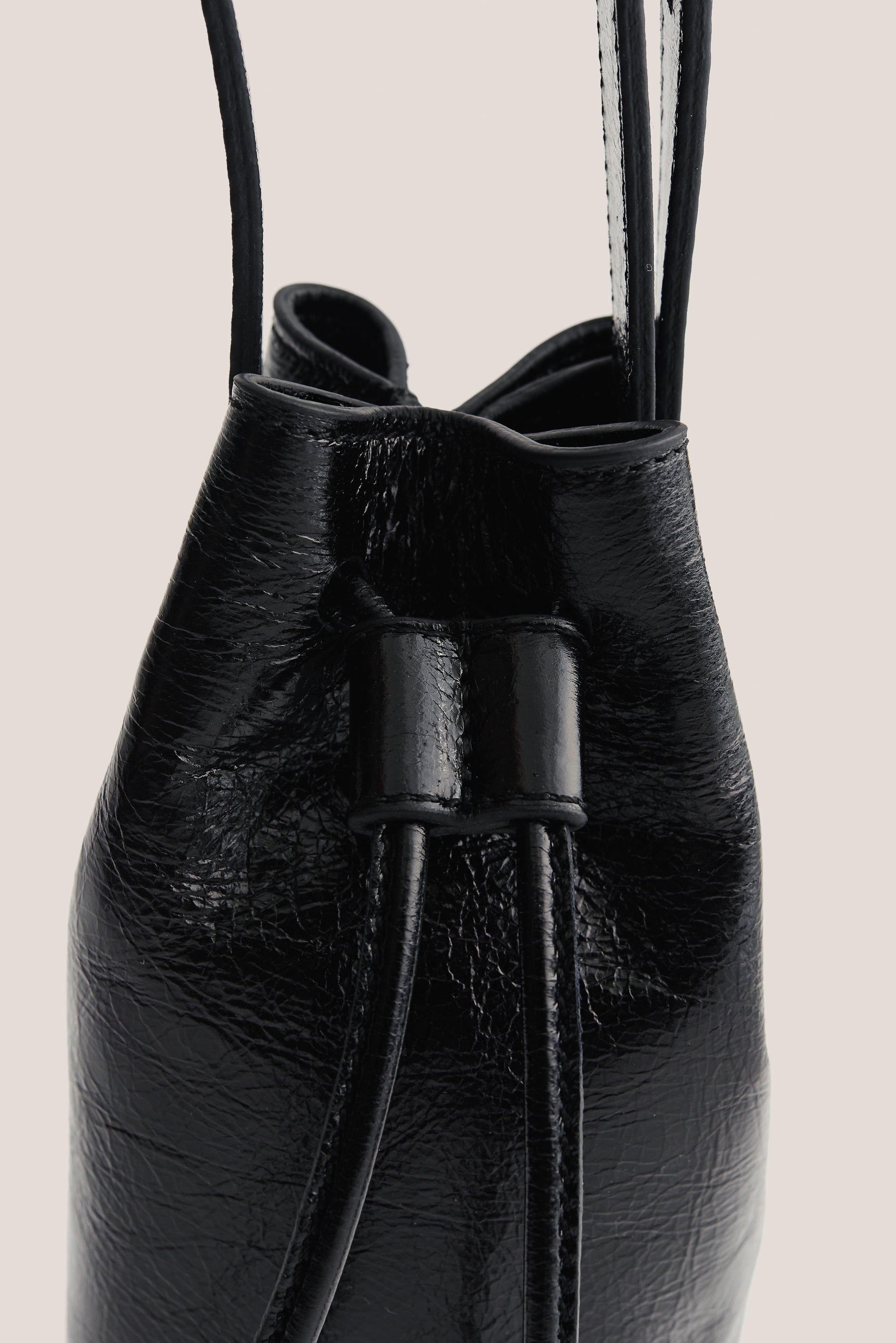 Women's accessories mini round bucket bag, black lwg-certified calf leather with drawstring closure.
