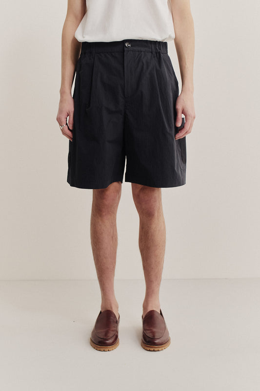 Men's shorts, black recycled nylon cotton blend, relaxed fit with front pleats and side patch pockets.